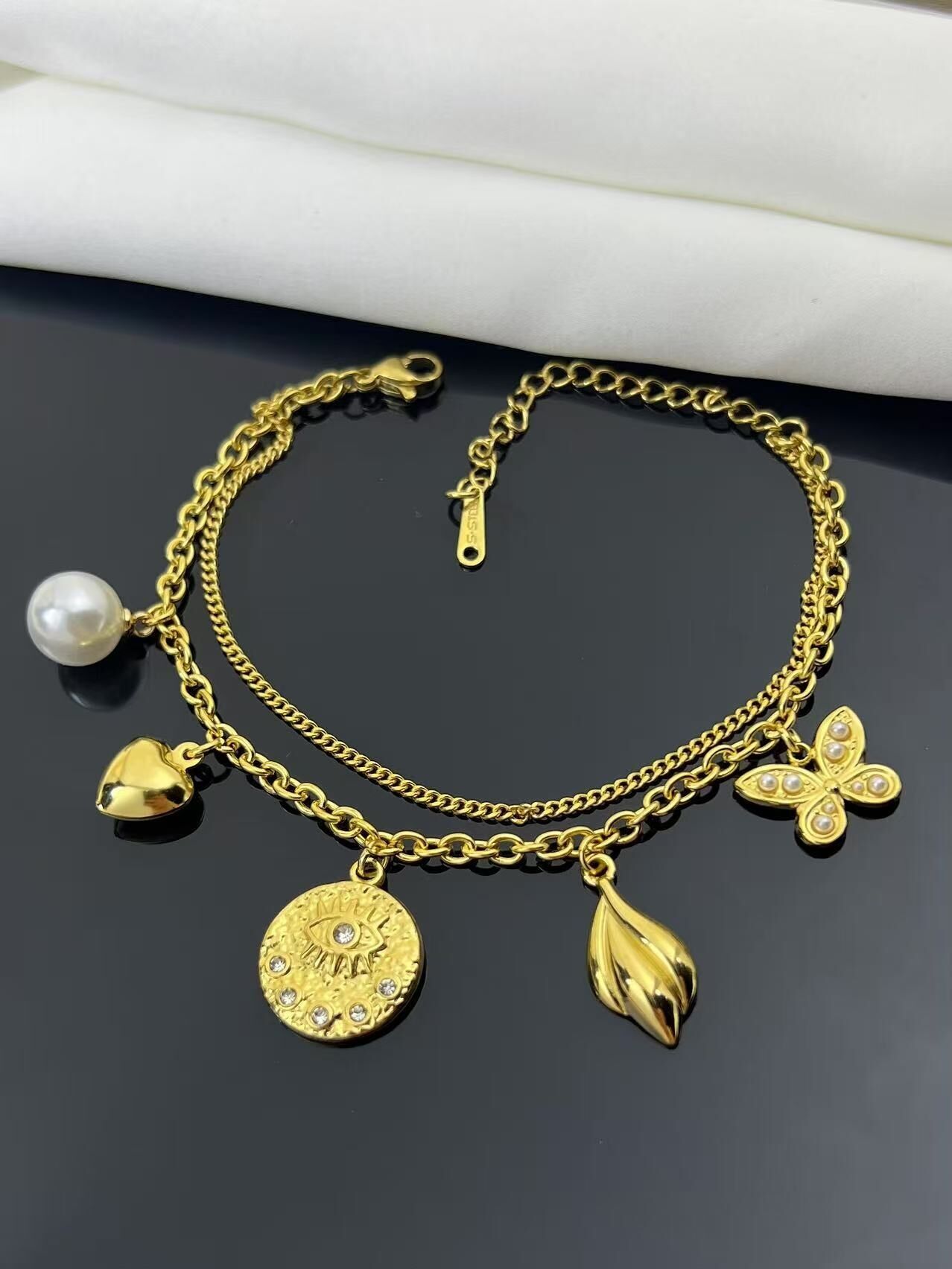 Double wrap bracelet with butterfly heart charms and medal