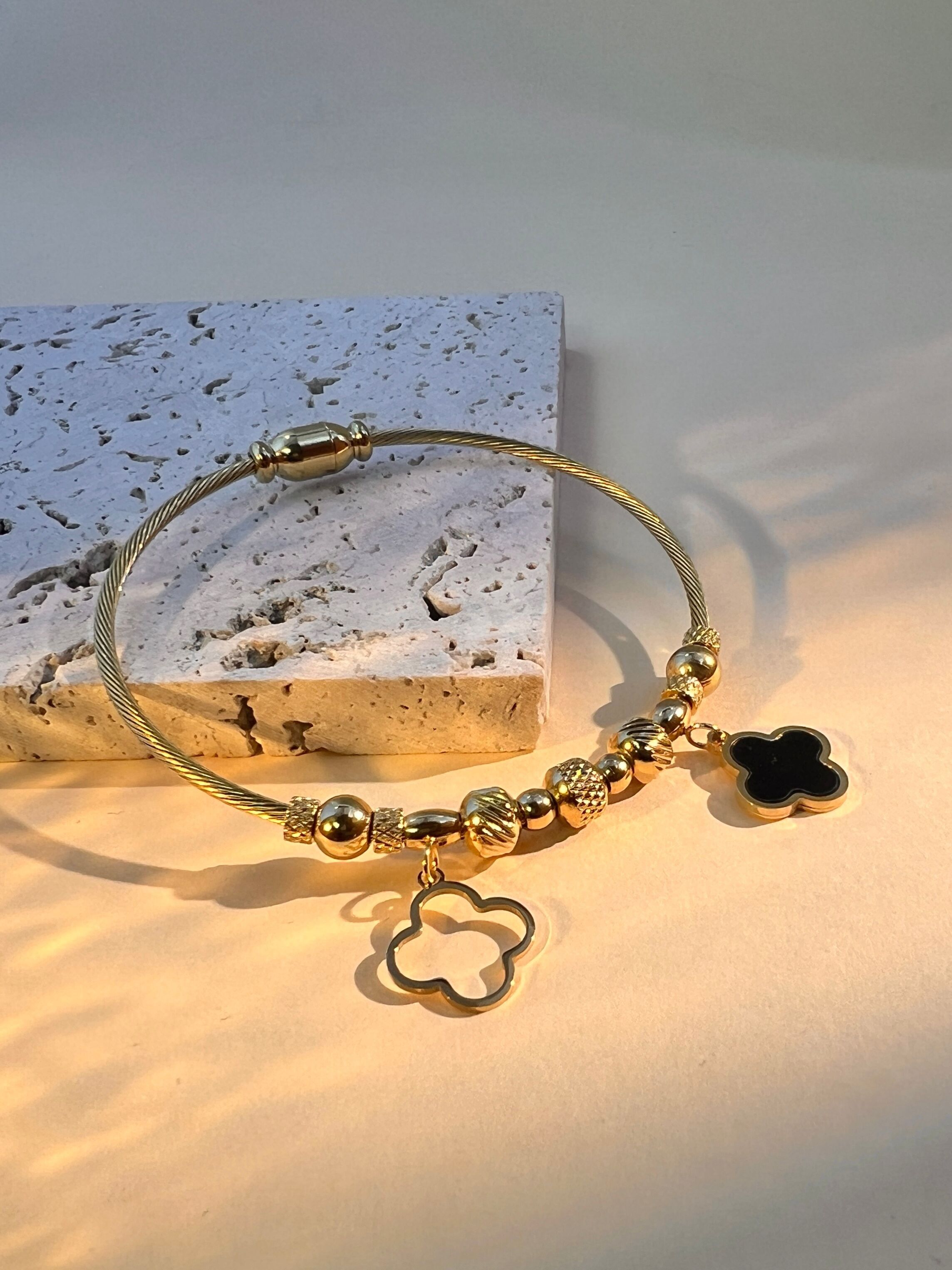 Stainless steel bangle bracelet with clover charms