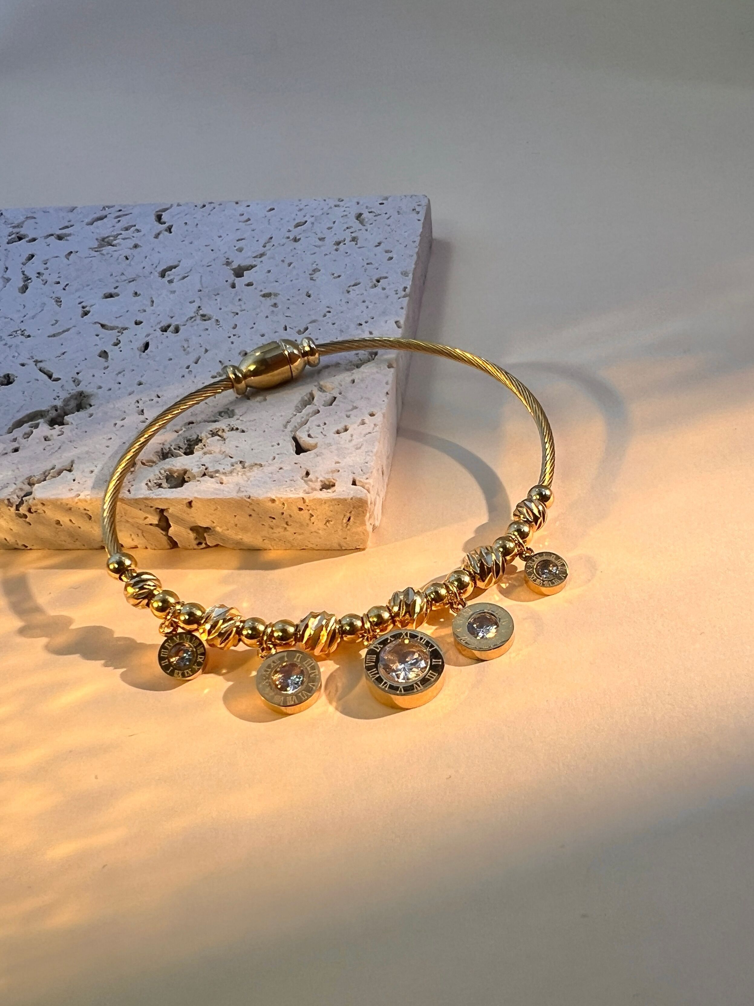 Stainless steel bangle bracelet with charms, modern elegance