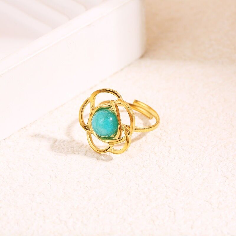Anello a forma di fiore in oro con pietra interna rotonda blu