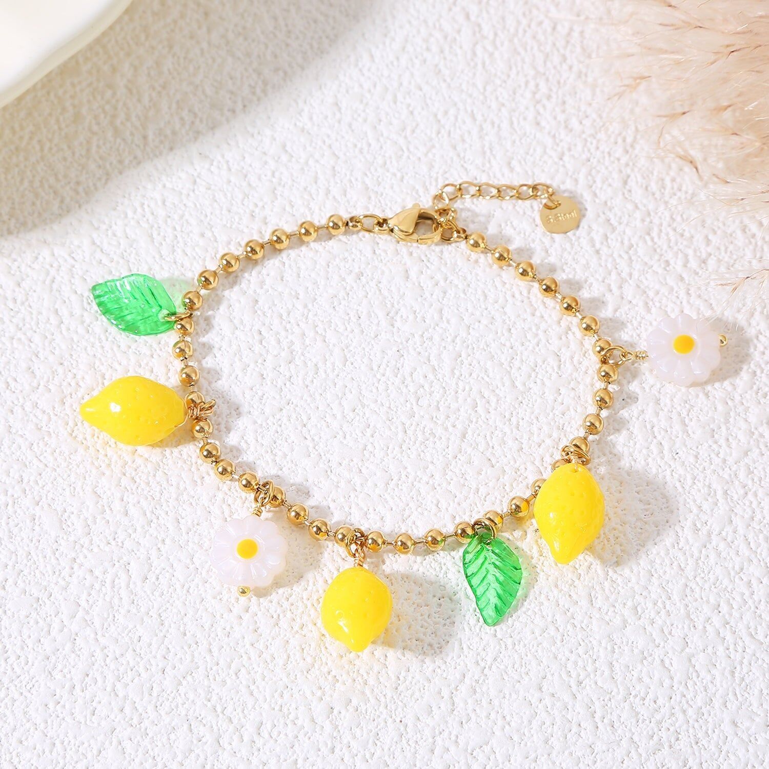 Bracciale a catena con palline in oro con limoni e margherite