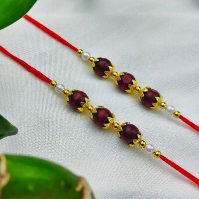 Rakhi de cuentas de sándalo rojo dorado para el Raksha Bandhan del hermano