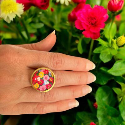 Multicolored Liberty Flower Ring on a green background with gold or silver finish