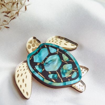 Broche tortue élégante découpée au laser dans du verre acrylique à motifs miroir doré, turquoise et noir