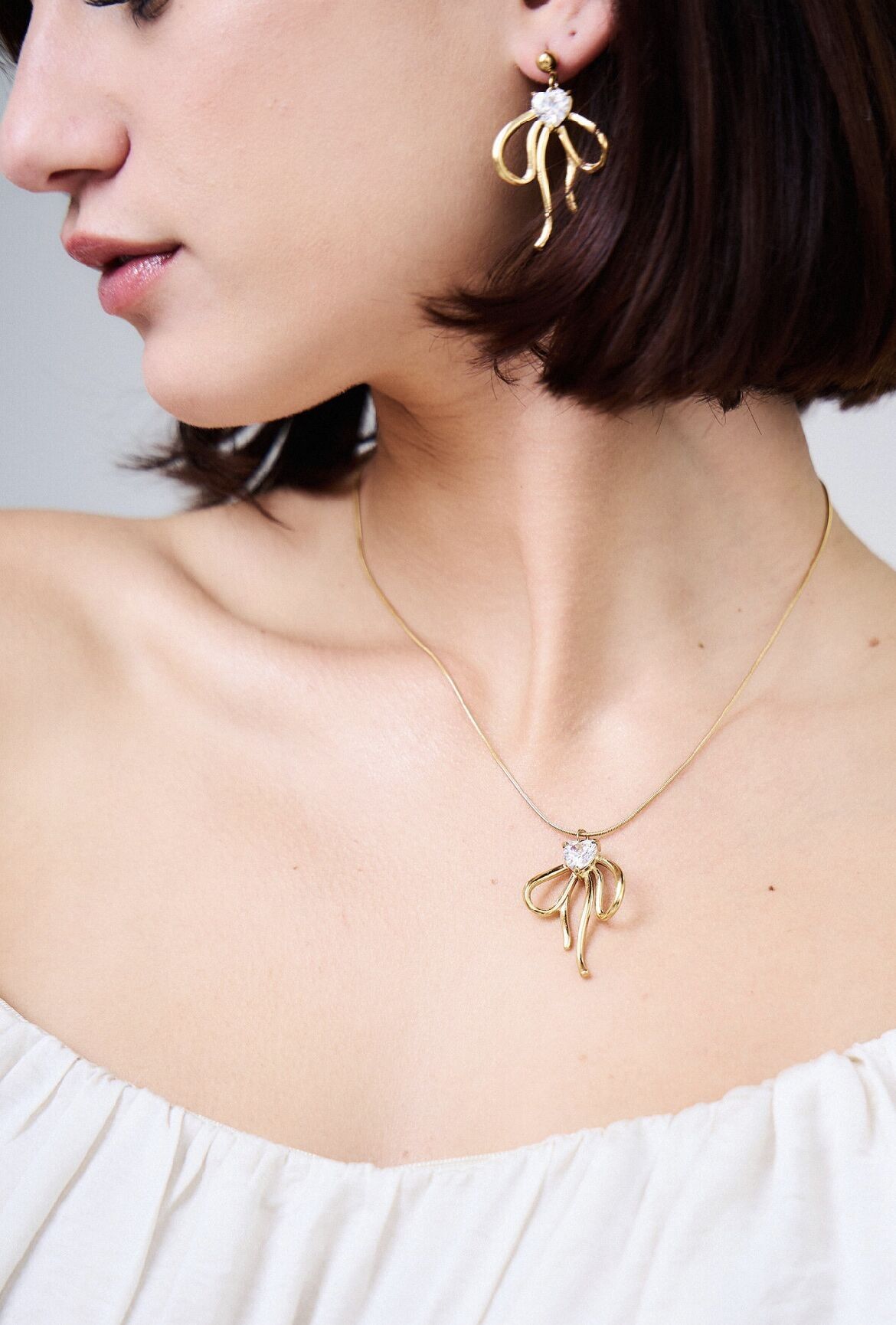 Collana con fiocco in cristallo in acciaio inossidabile