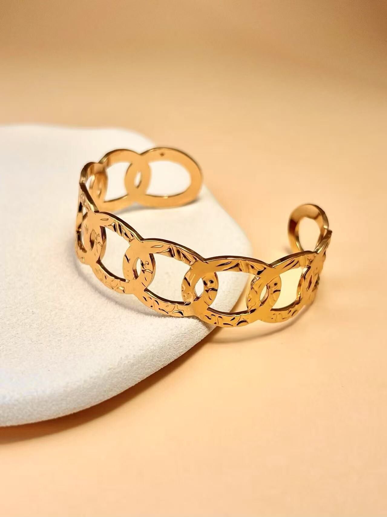 Bracciale rigido in oro con maglie intrecciate scolpite