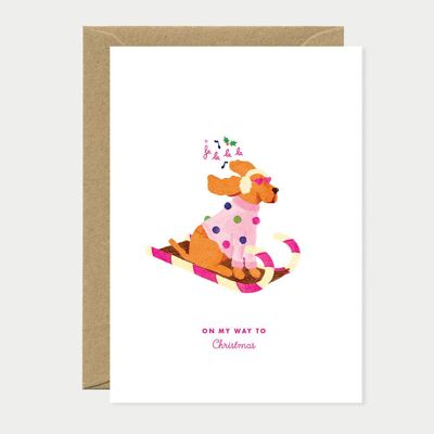 Tarjeta de felicitación navideña con trineo tirado por perros