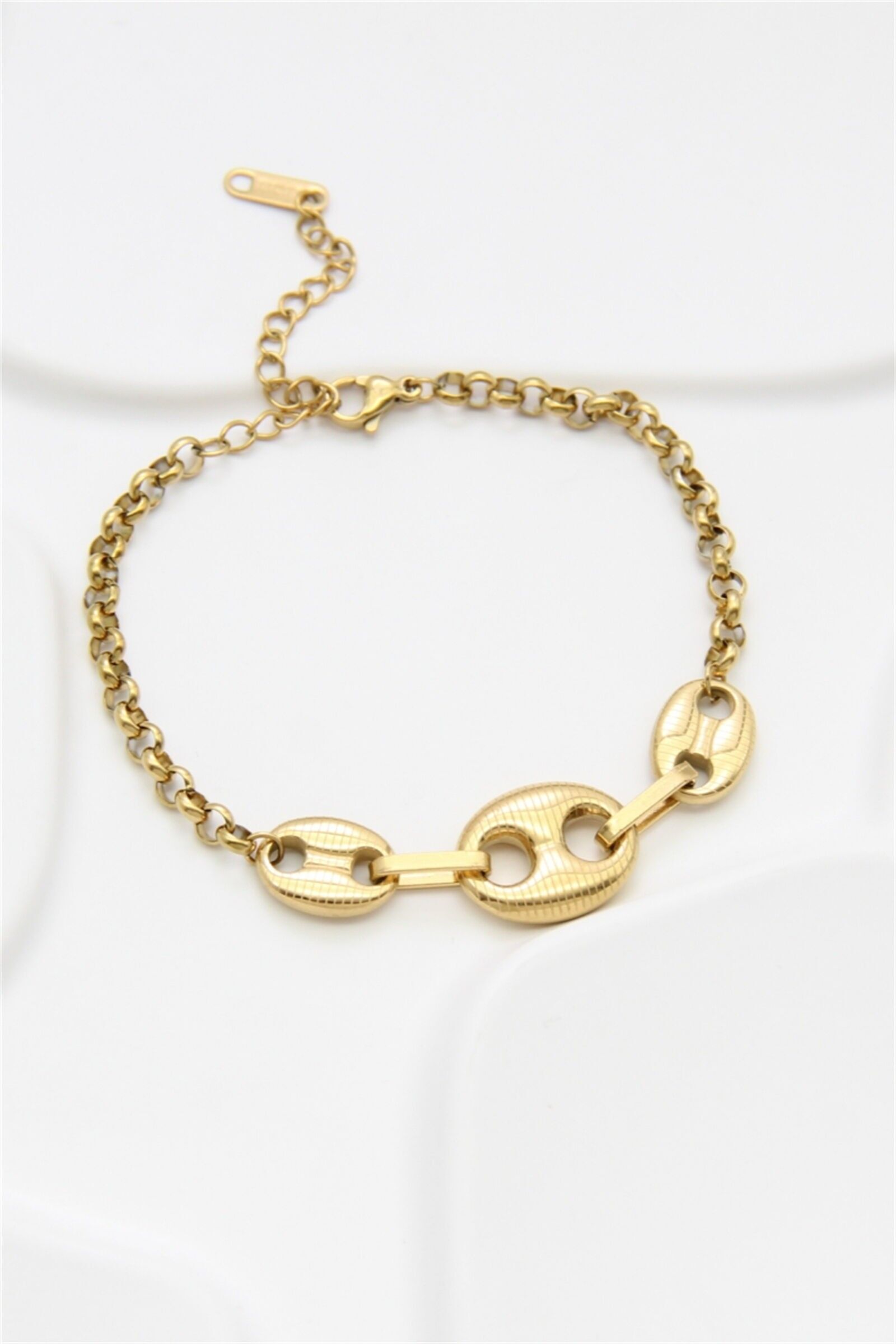 Goldener Kettenimpulsgeber aus Edelstahl mit strukturierten ovalen Klingen und röhrenförmigen Stäben.