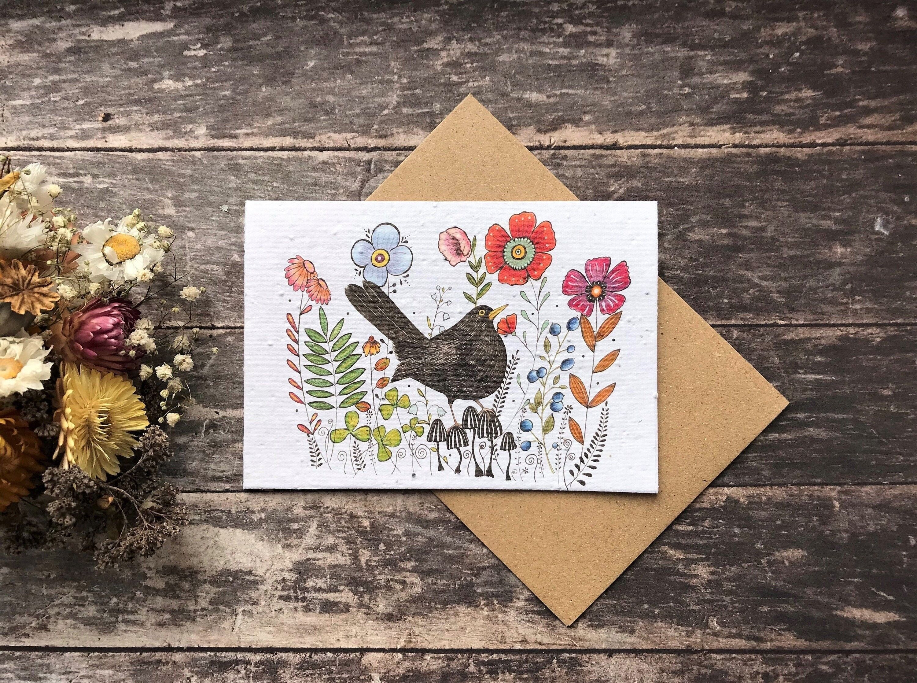 Biglietto di auguri di compleanno con semi piantumabili: uccello nero e fiori