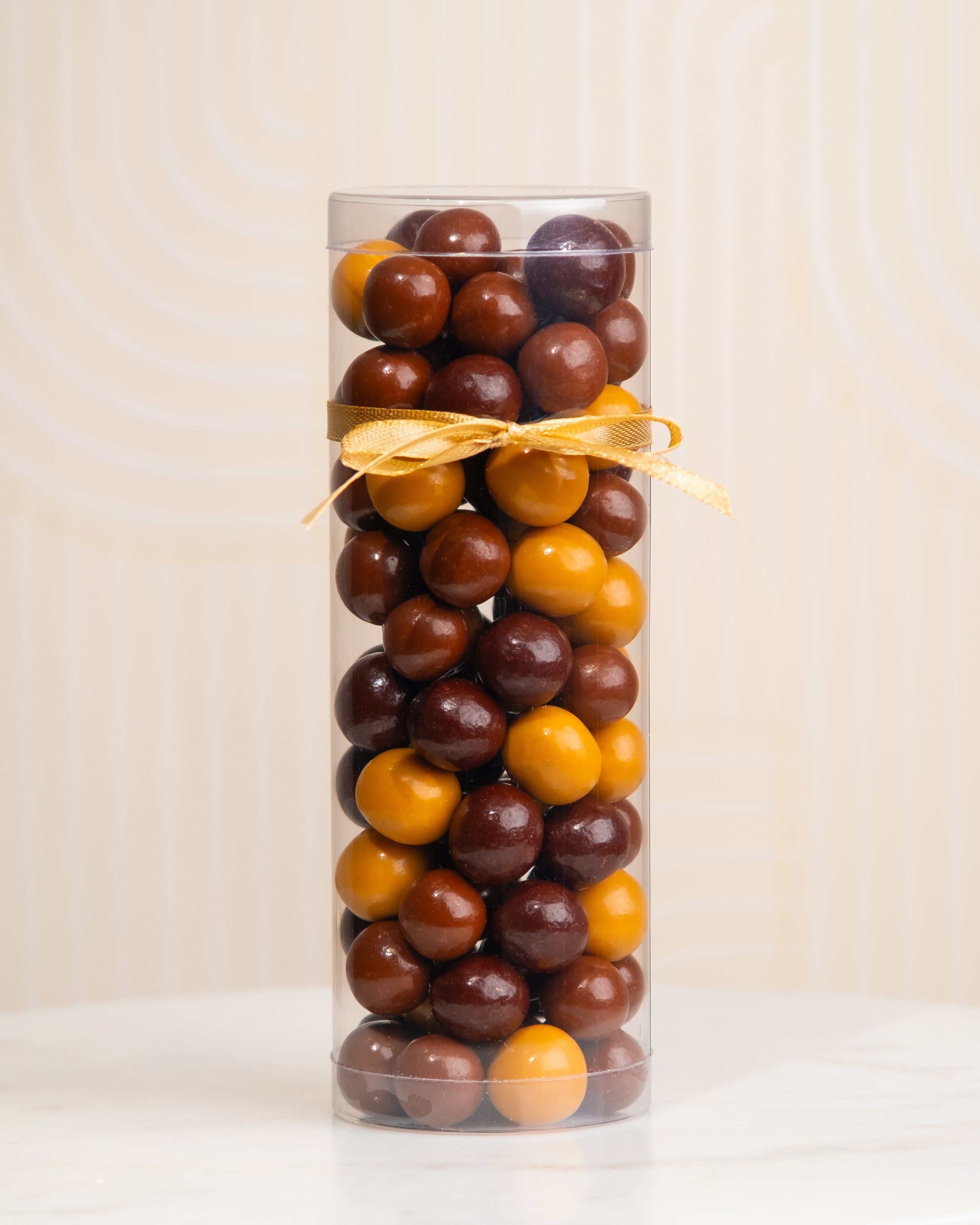 Dark, milk, and Dulcey chocolate hazelnut balls - Clear tube