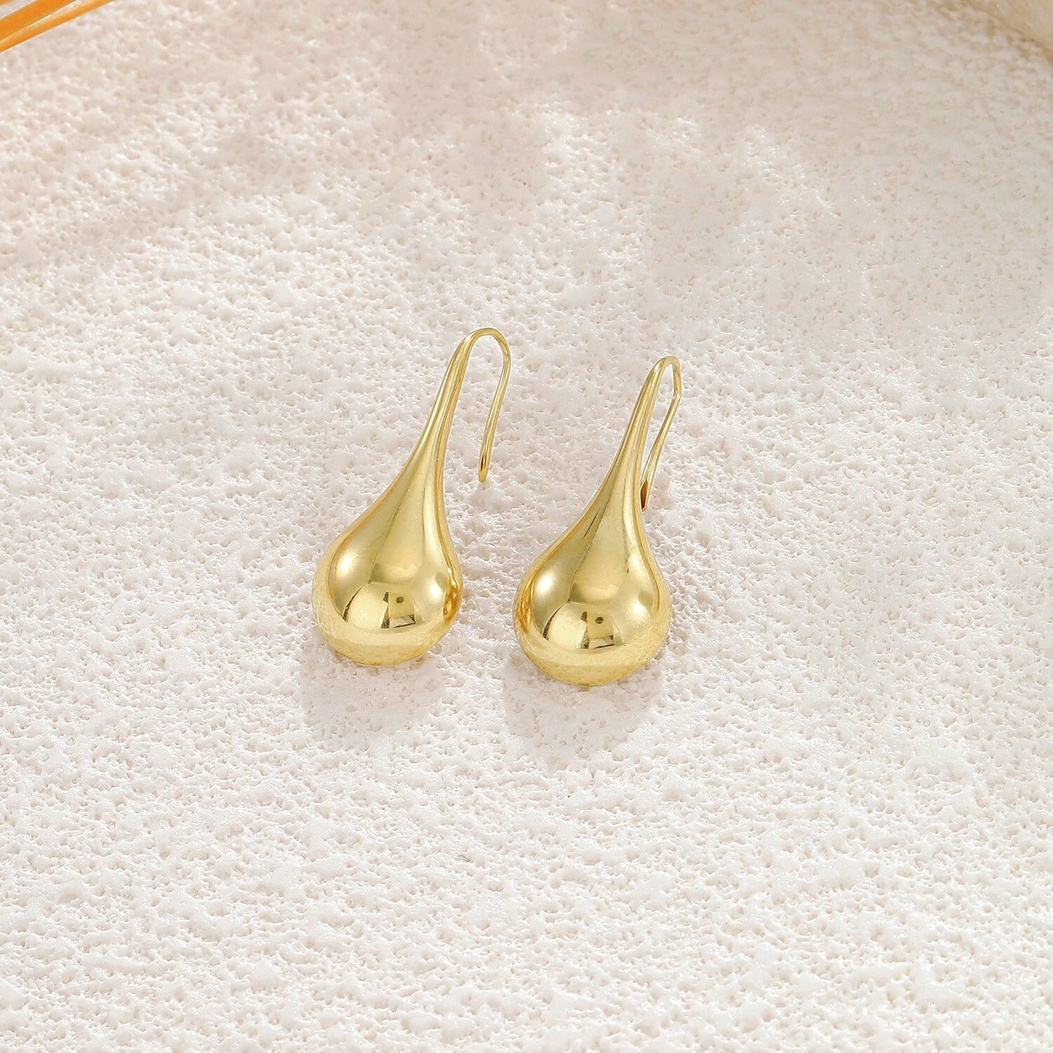 Orecchini pendenti in oro con effetto specchio