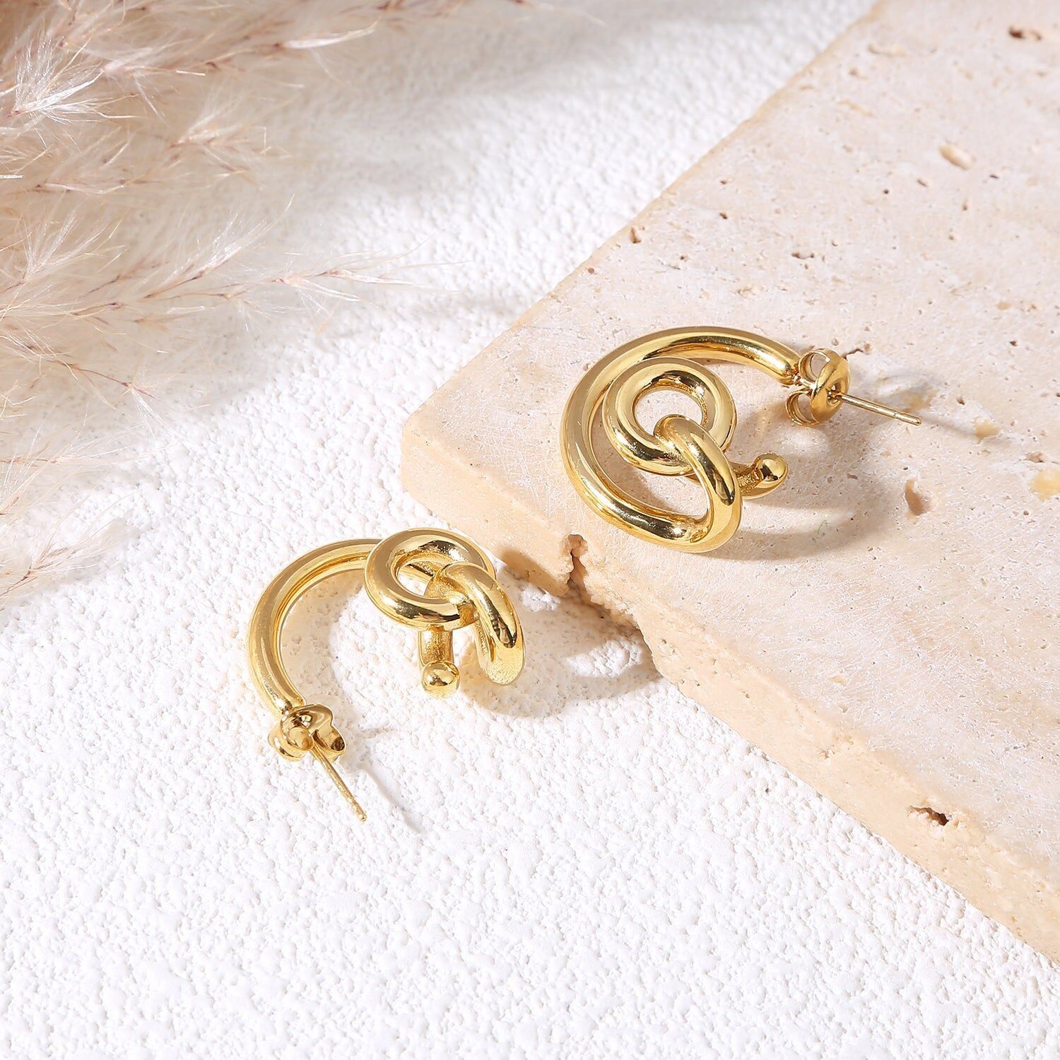 Orecchini a cerchio in oro spesso con anello centrale intrecciato ed effetto specchio