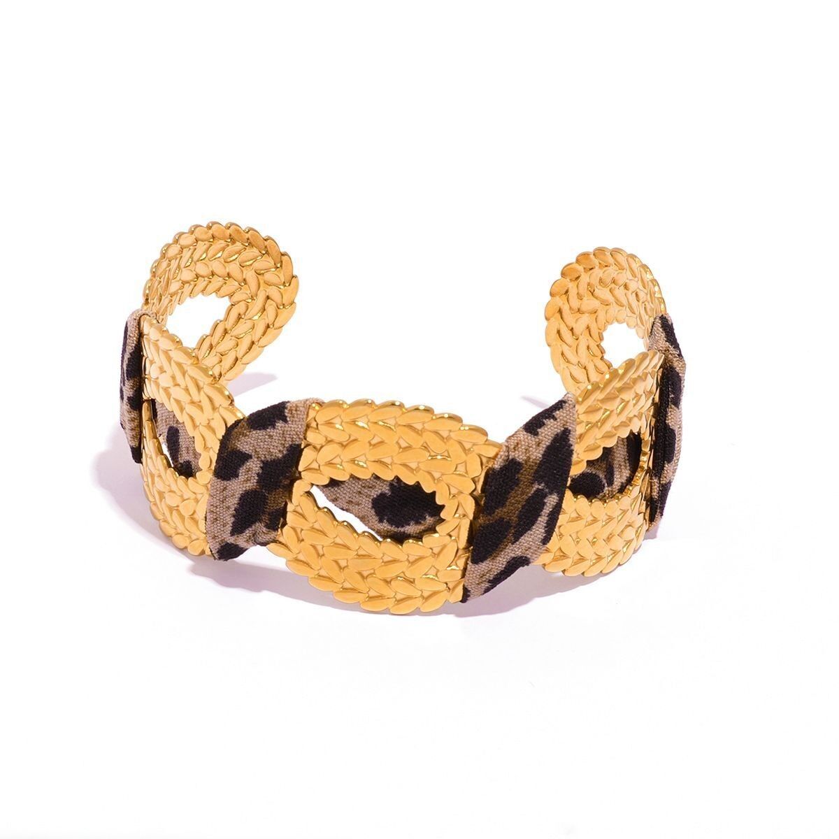 Bracciale spesso regolabile color oro con parte anteriore traforata e strutturata, circondato da tessuto con stampa leopardata