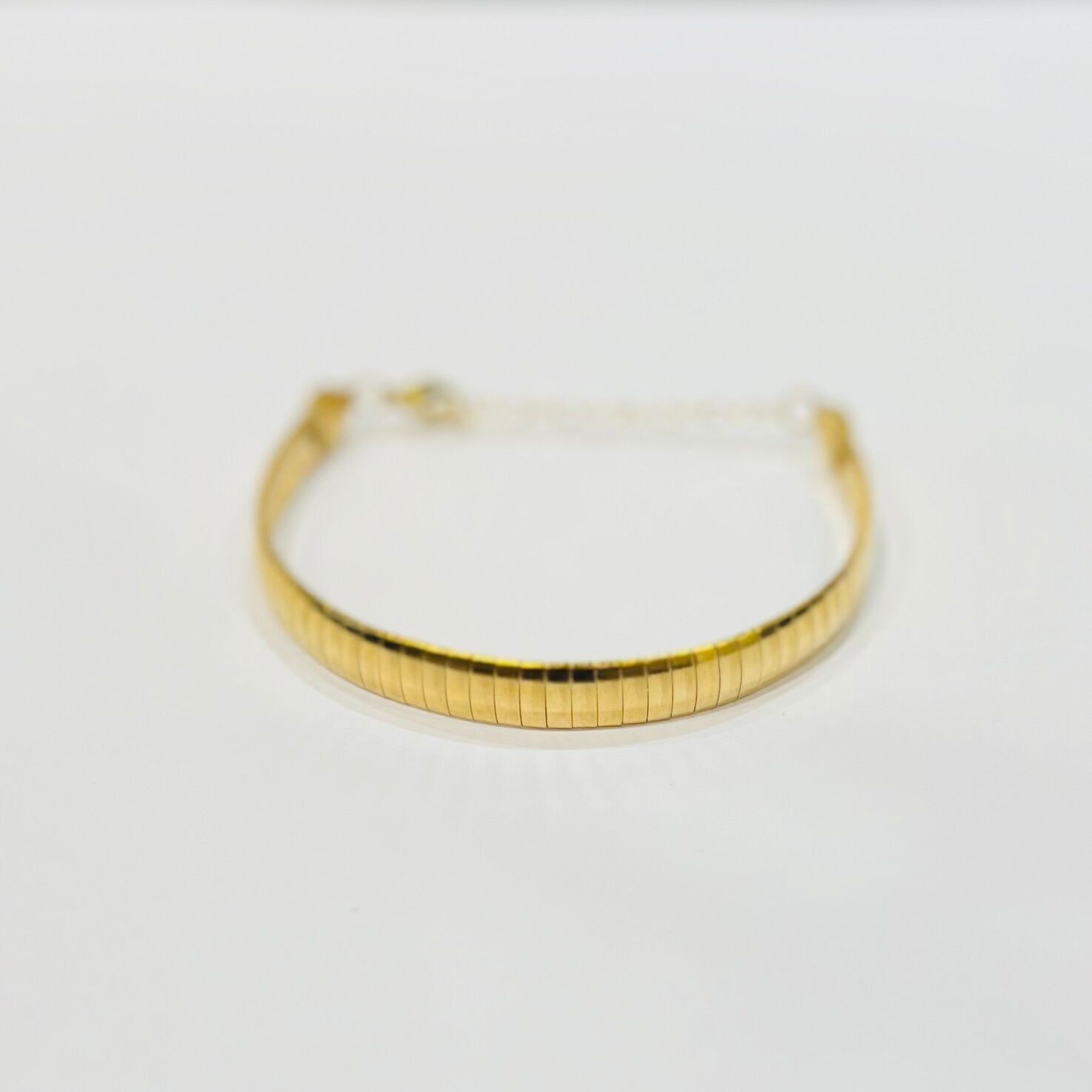 Bracciale in acciaio placcato oro con maglia rigida piatta a serpente