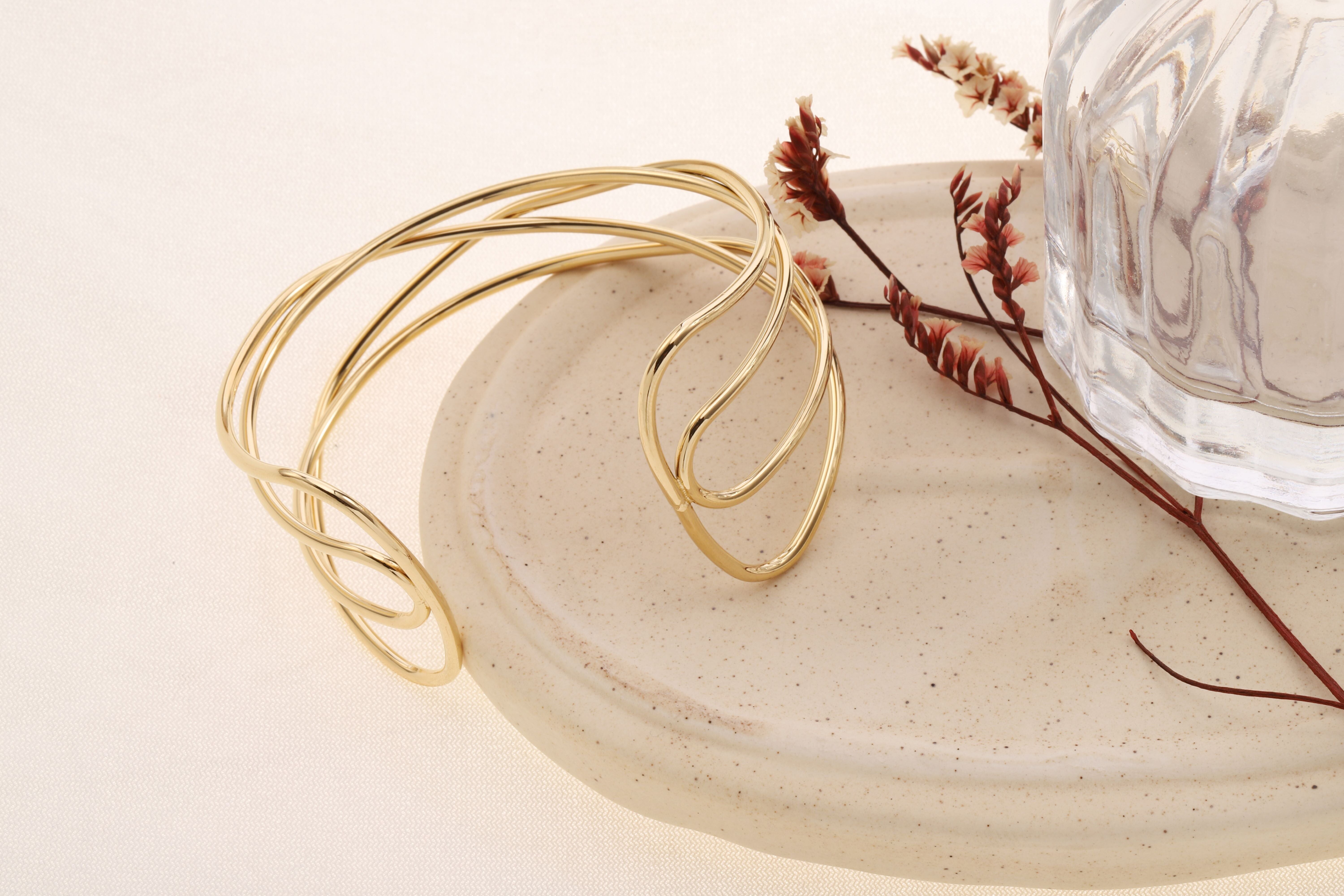 Bracciale rigido regolabile in oro con 4 rami intrecciati