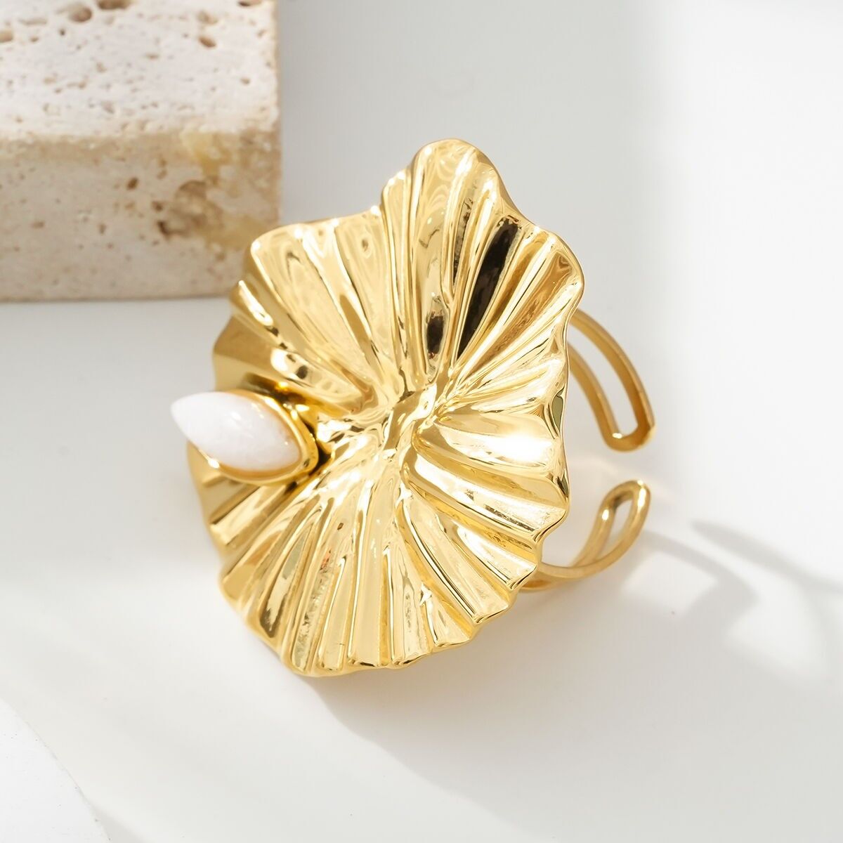Anello con foglia di loto dorata decorato con pietra bianca