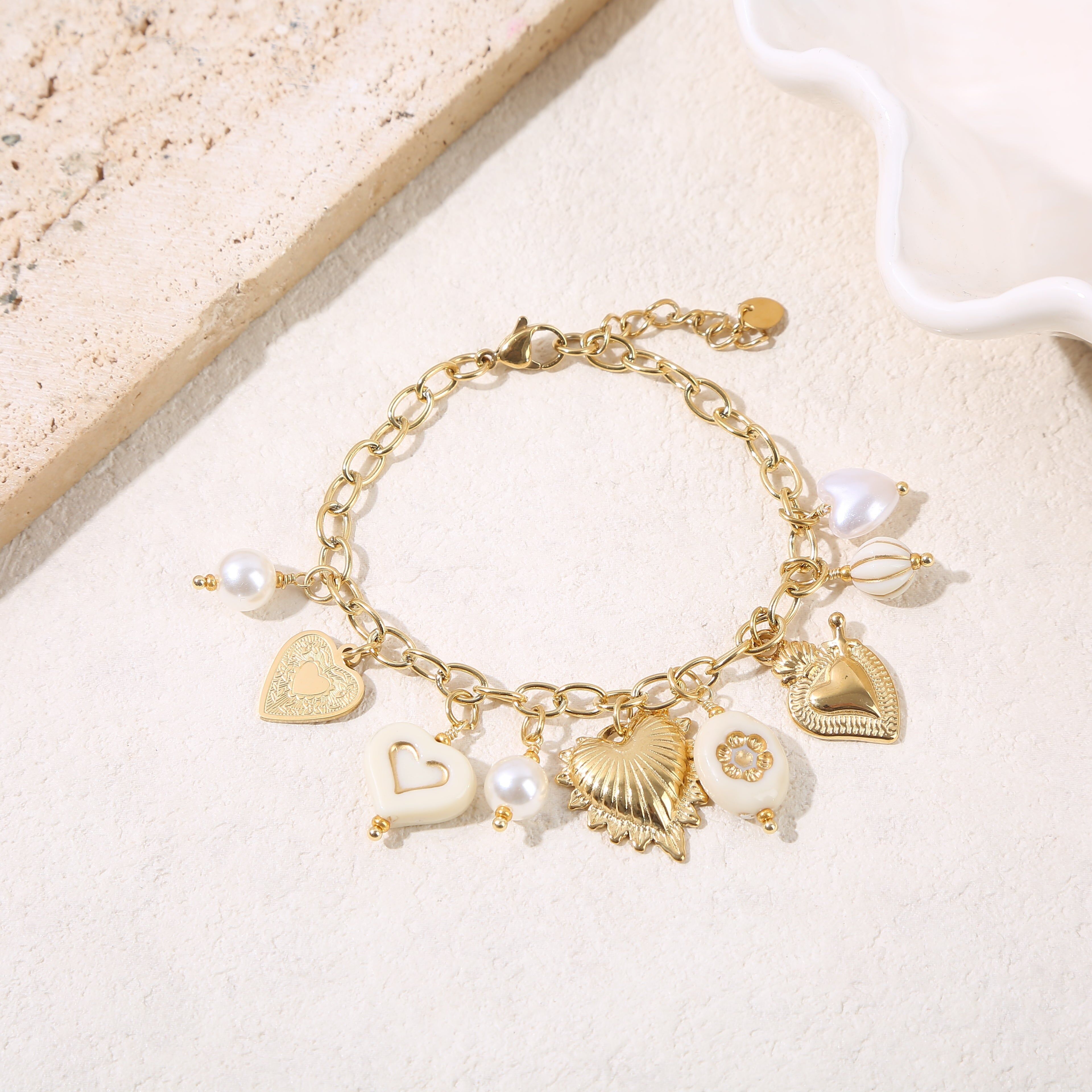 Gold chain bracelet with heart charms and beige resin