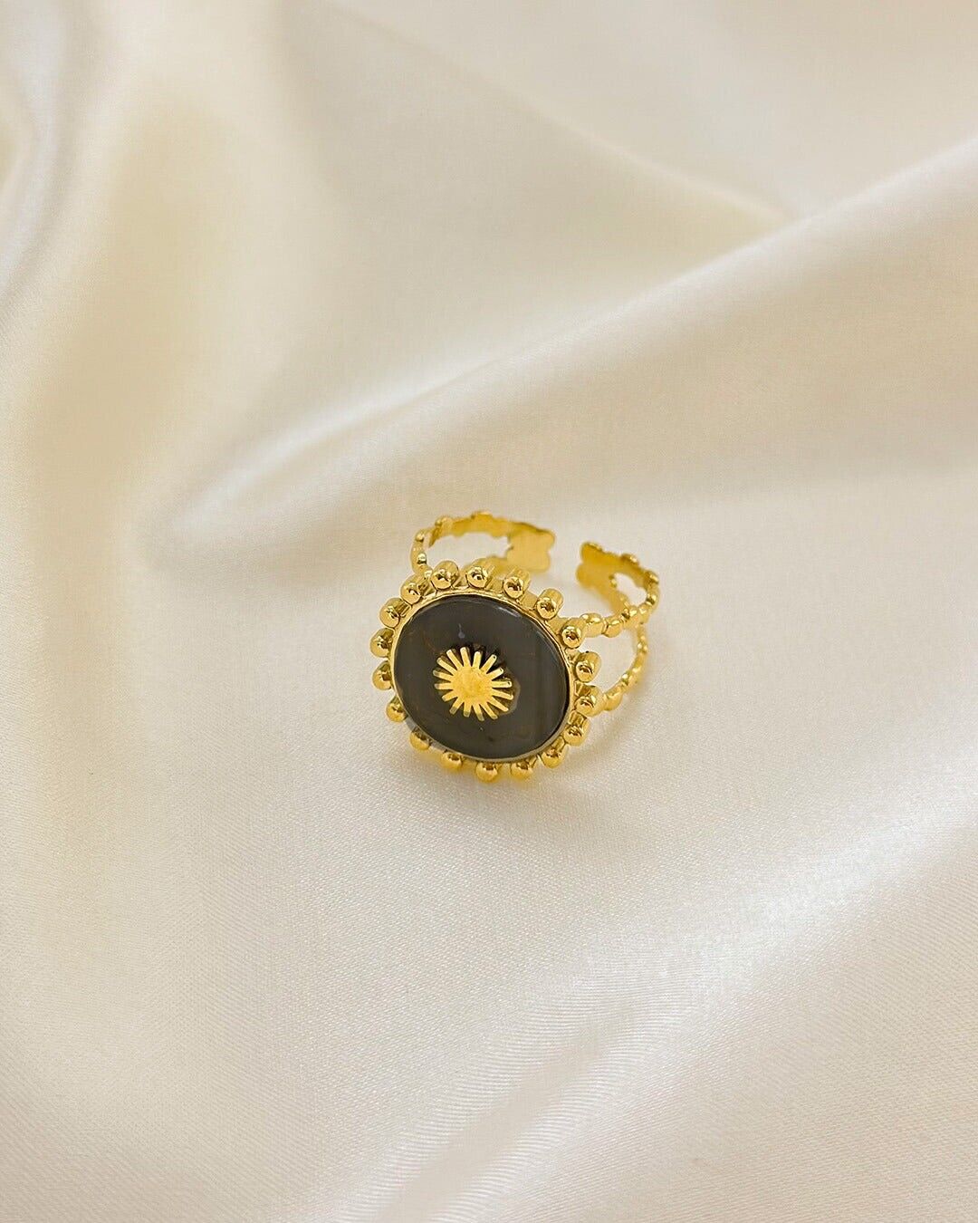 Open Gold Ring with Sunburst Frame and Black Stone Inlay