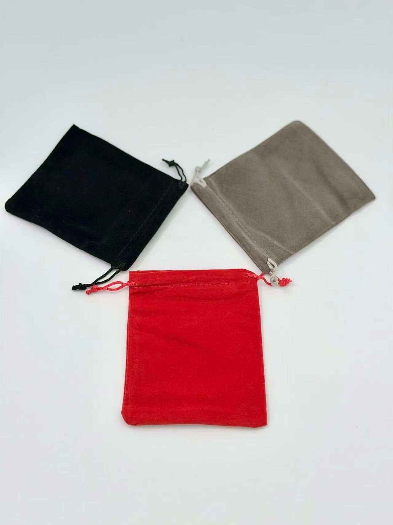 Pack of 50 festive velvet-effect pouches in red, black, and grey