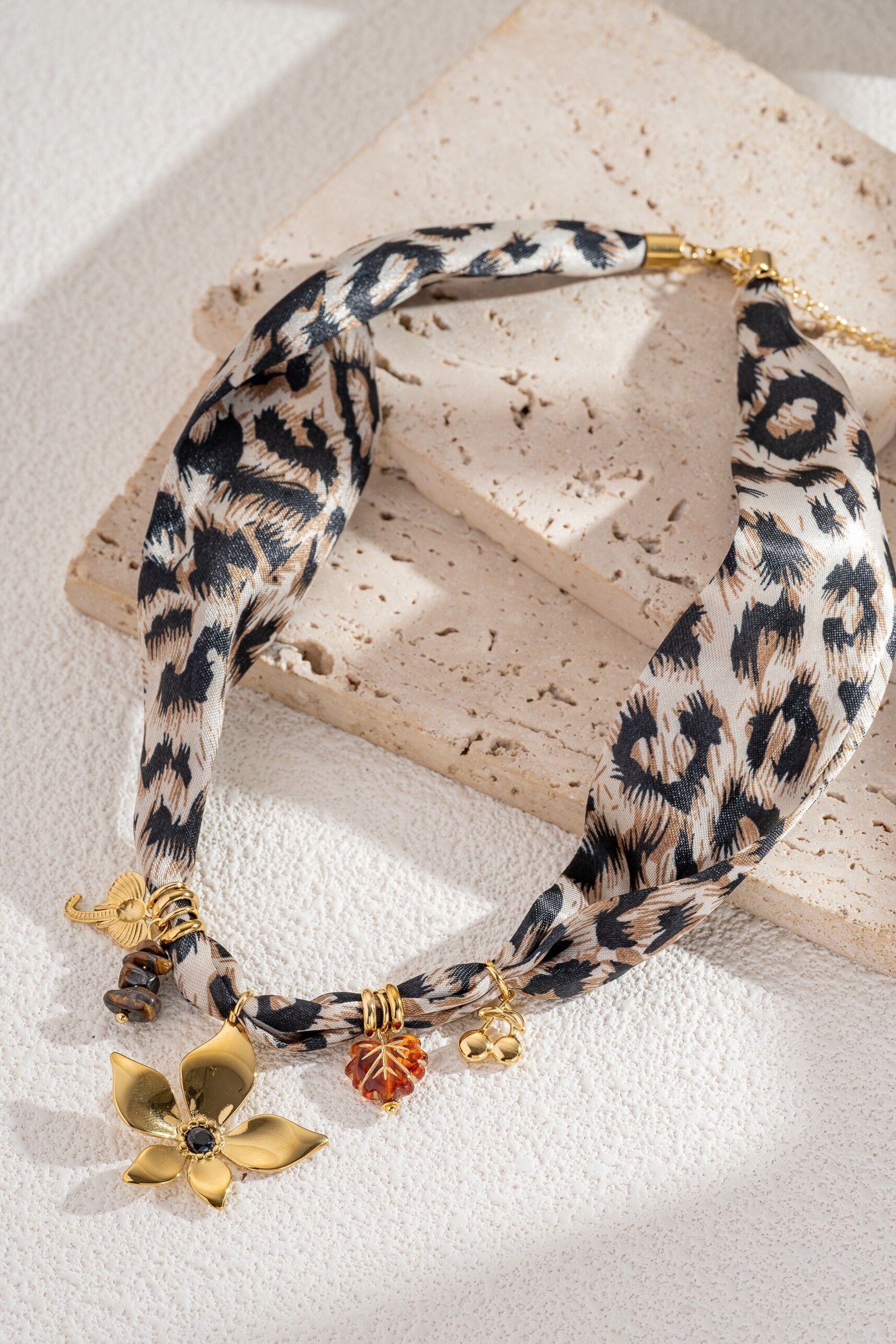 Leopard print necklace in fabric and stainless steel, with gold-tone charms