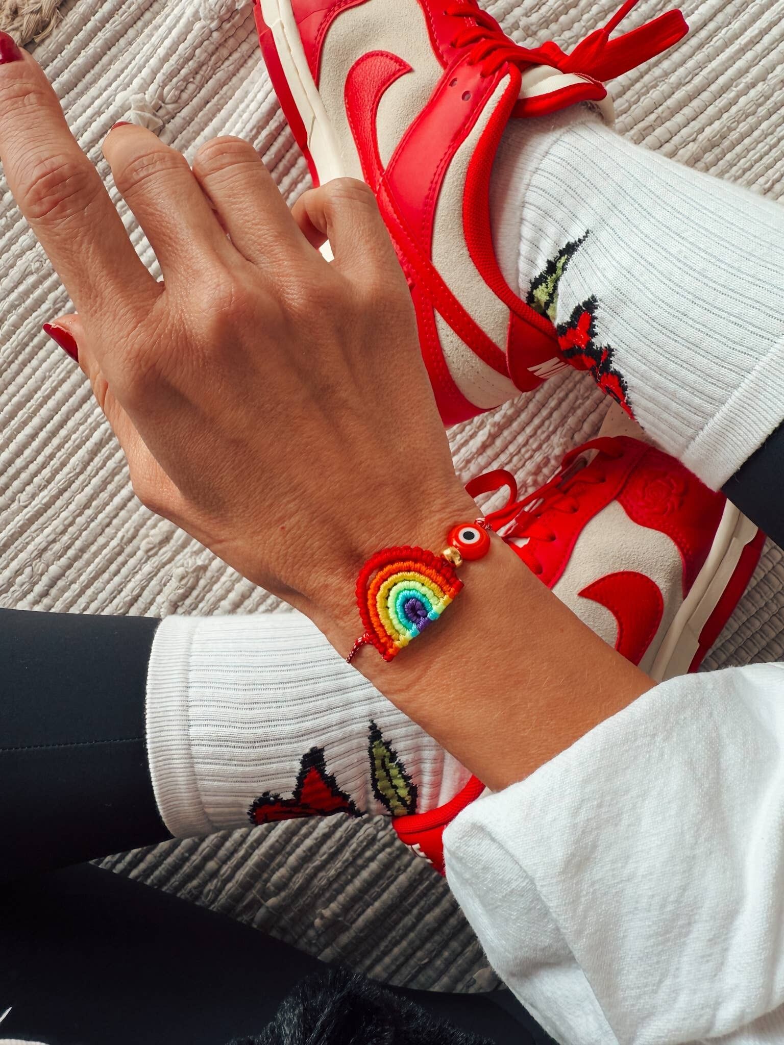 Spring bracelet with red cord and handmade rainbow