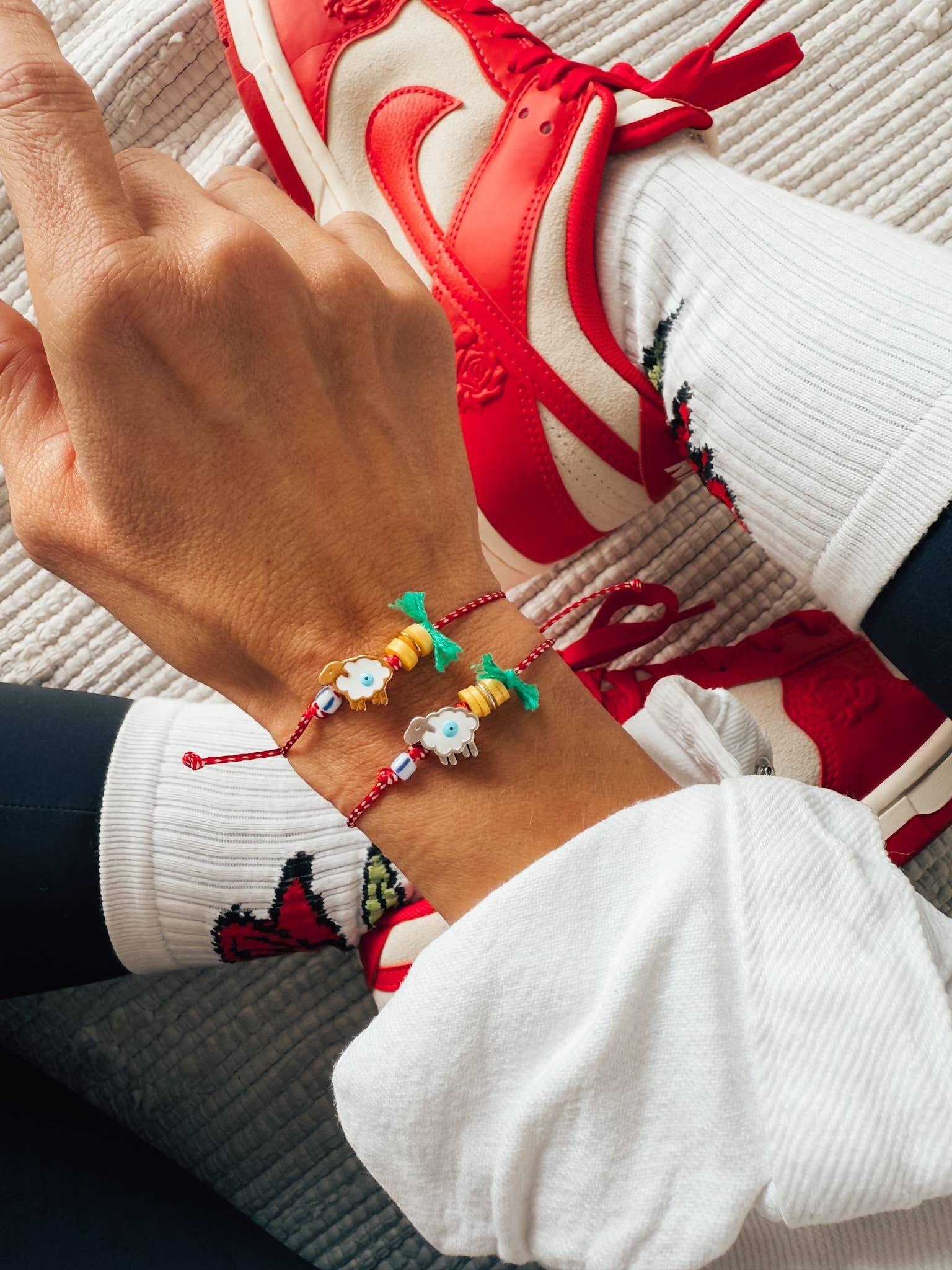 Spring bracelet with red cord and sheep detail