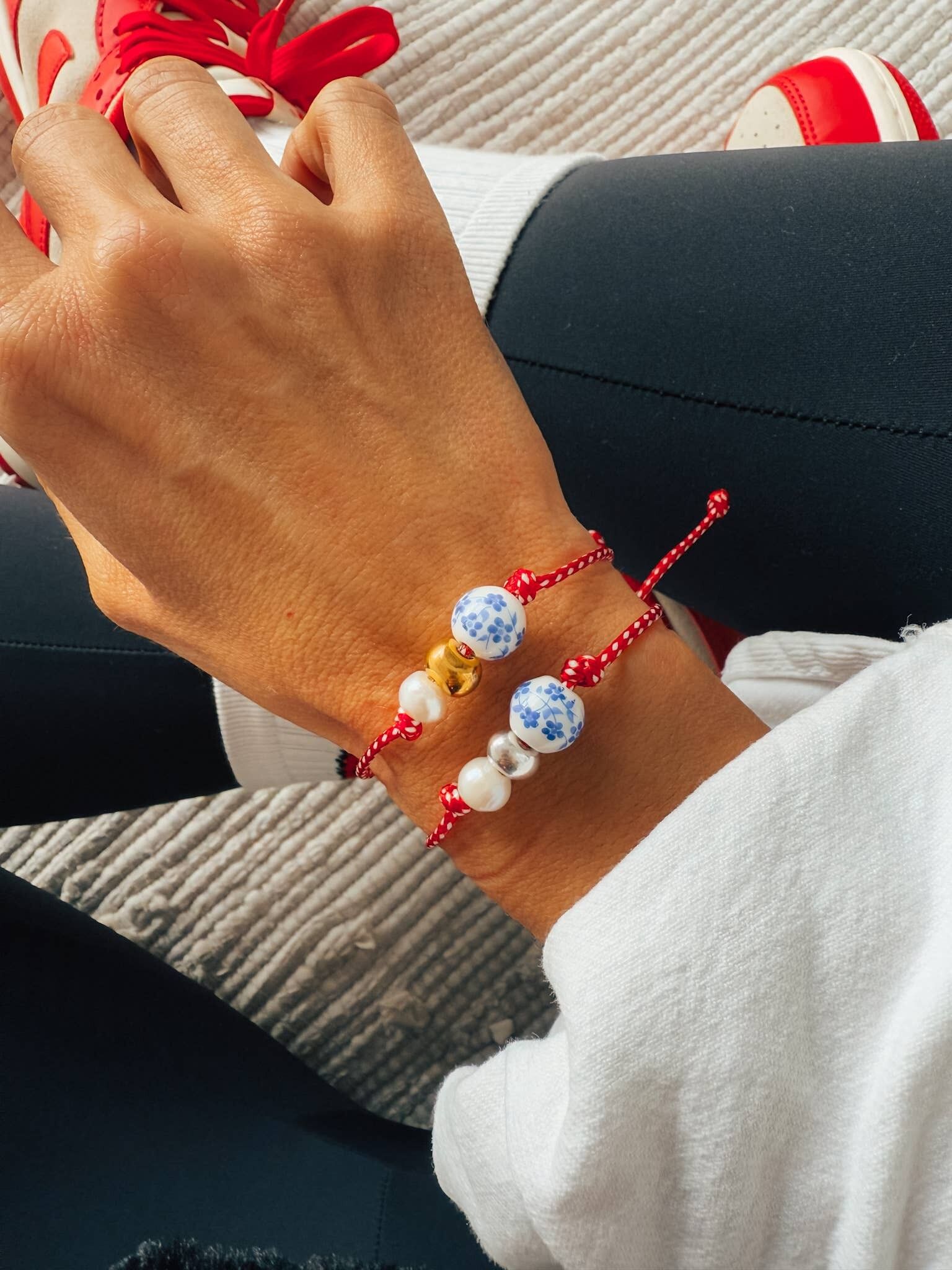 Spring bracelet with red cord porcelain bead and pearl