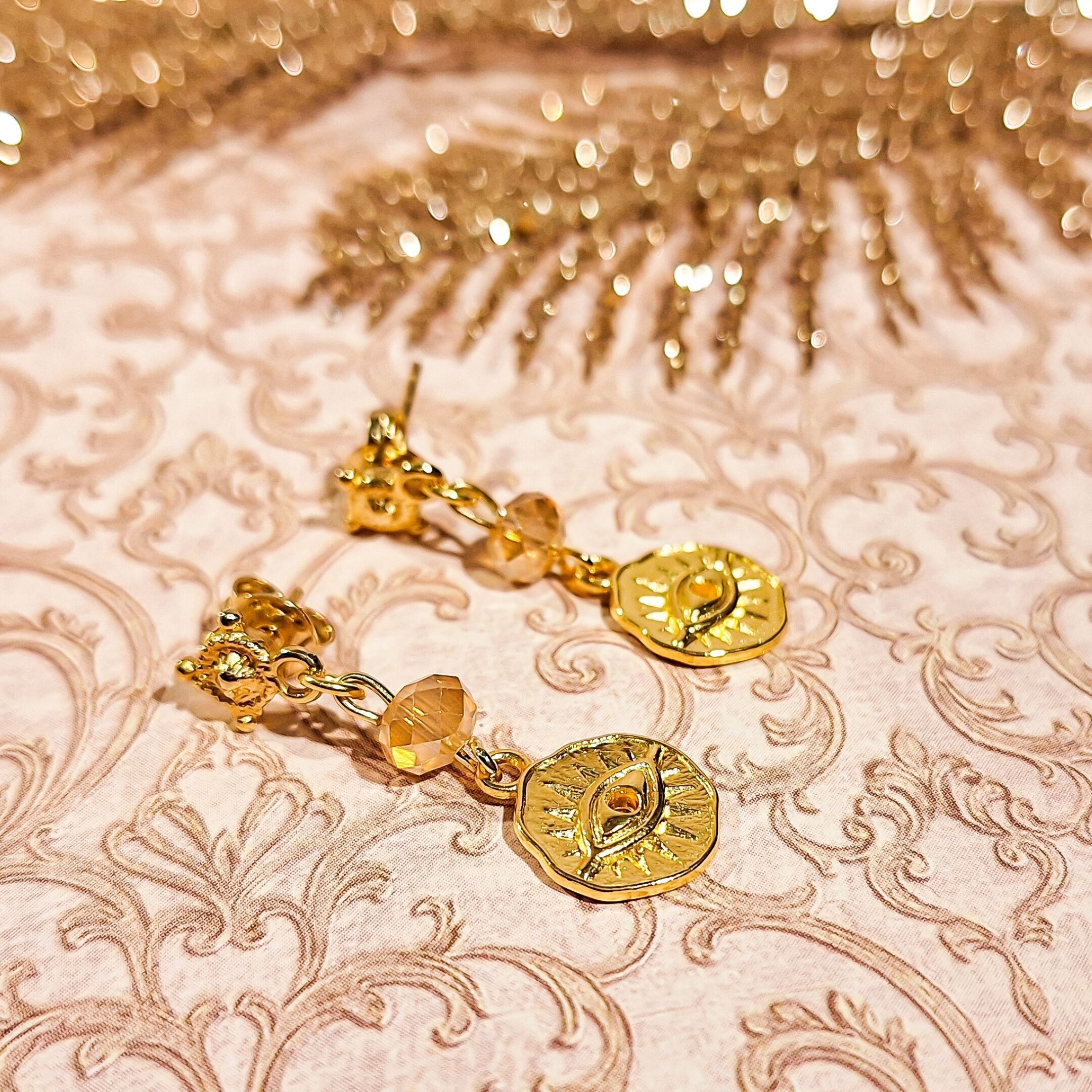 Gold-tone pearl pendant earrings with eye charm