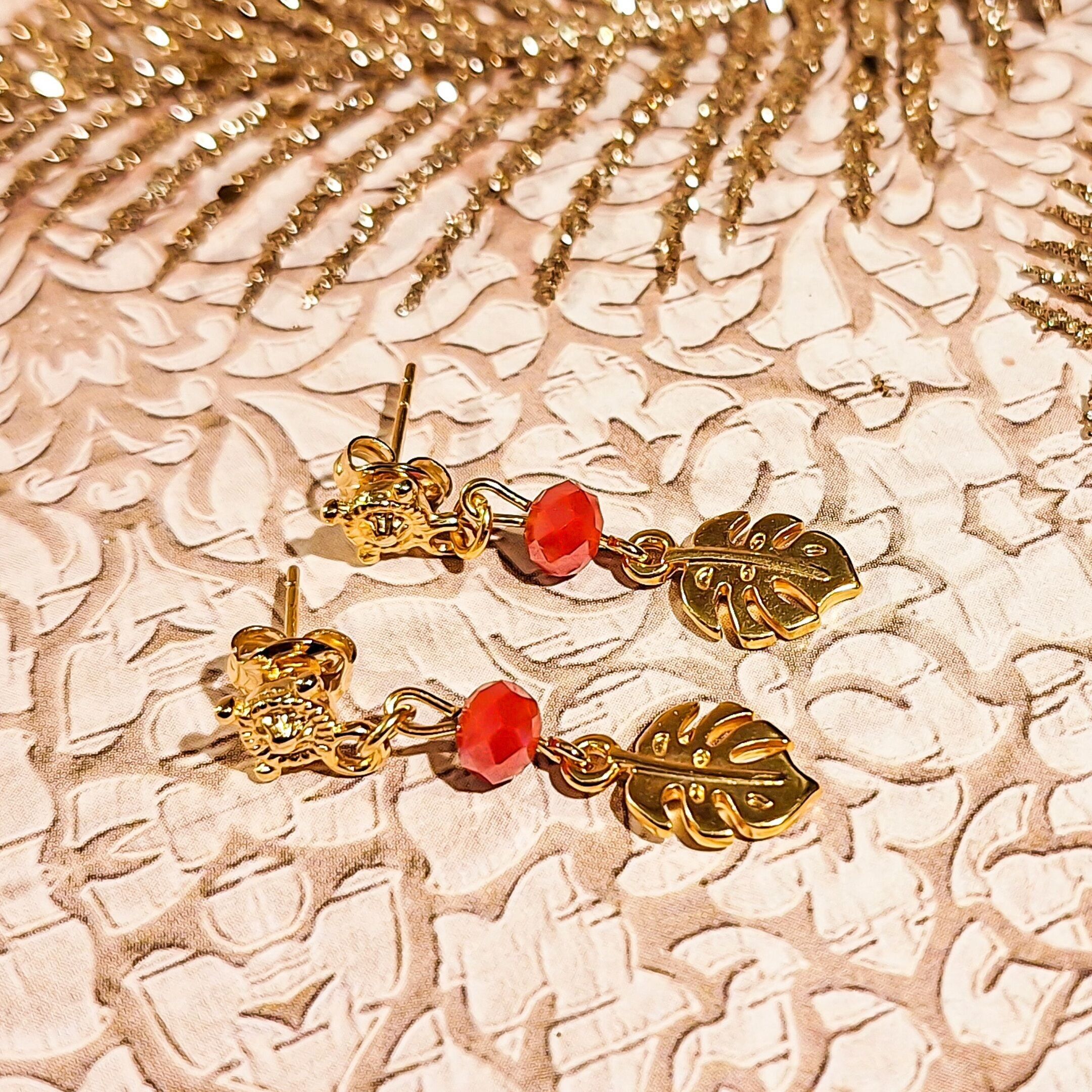 Gold-tone pearl earrings with monstera leaf pendants