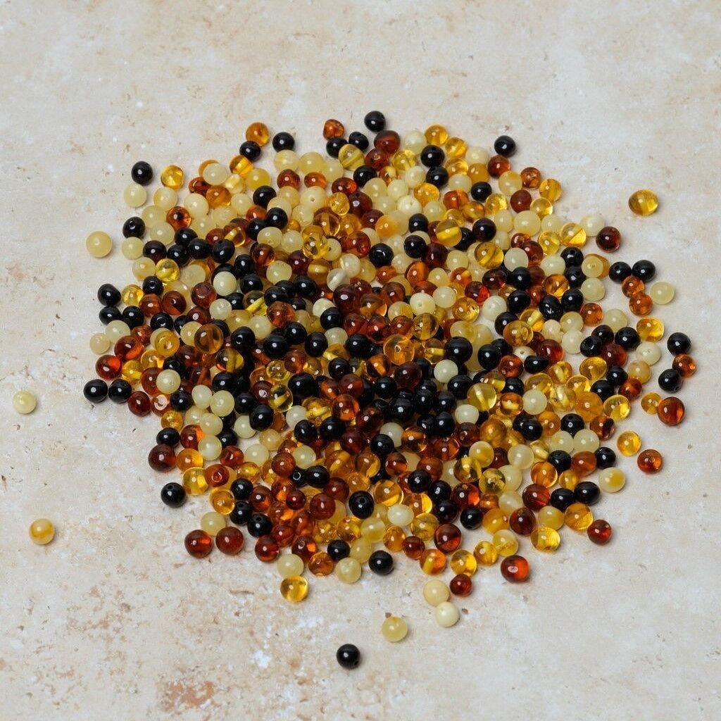 Perle di ambra traforate barocche multicolore 50 gr (~600 pz)