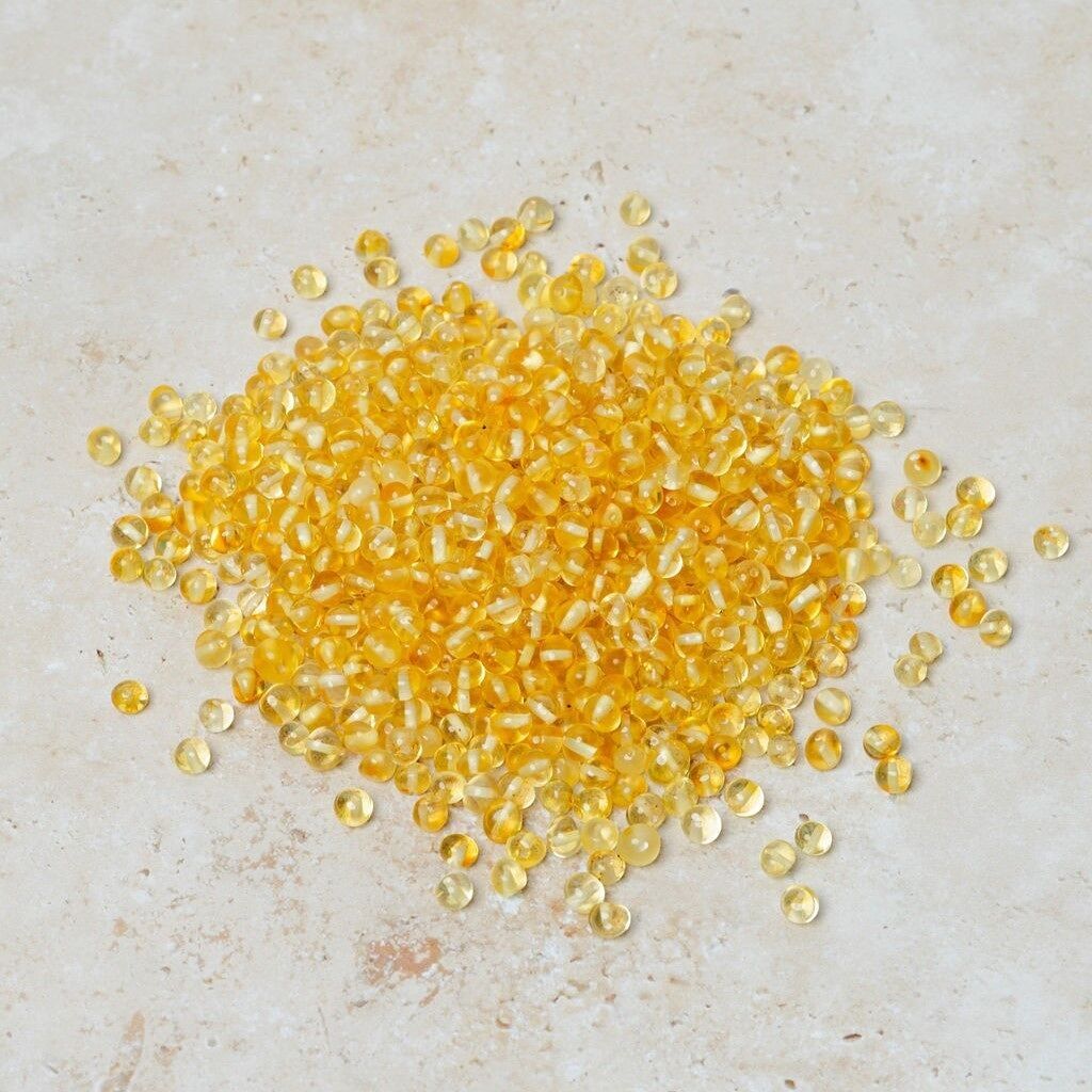 Perle di ambra traforate barocche limone 50 gr (~600 pz)