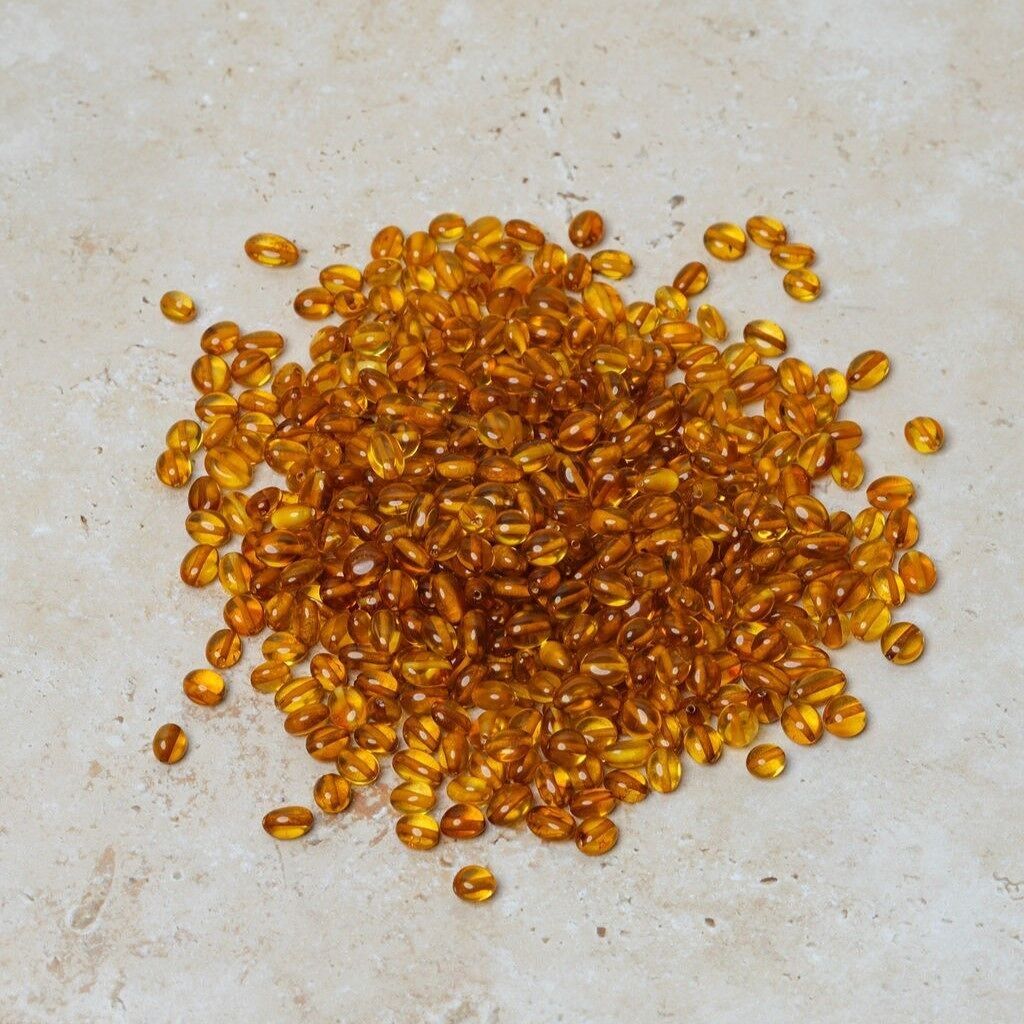 Perle di ambra forate ovali color miele 50 gr (~400 pz)