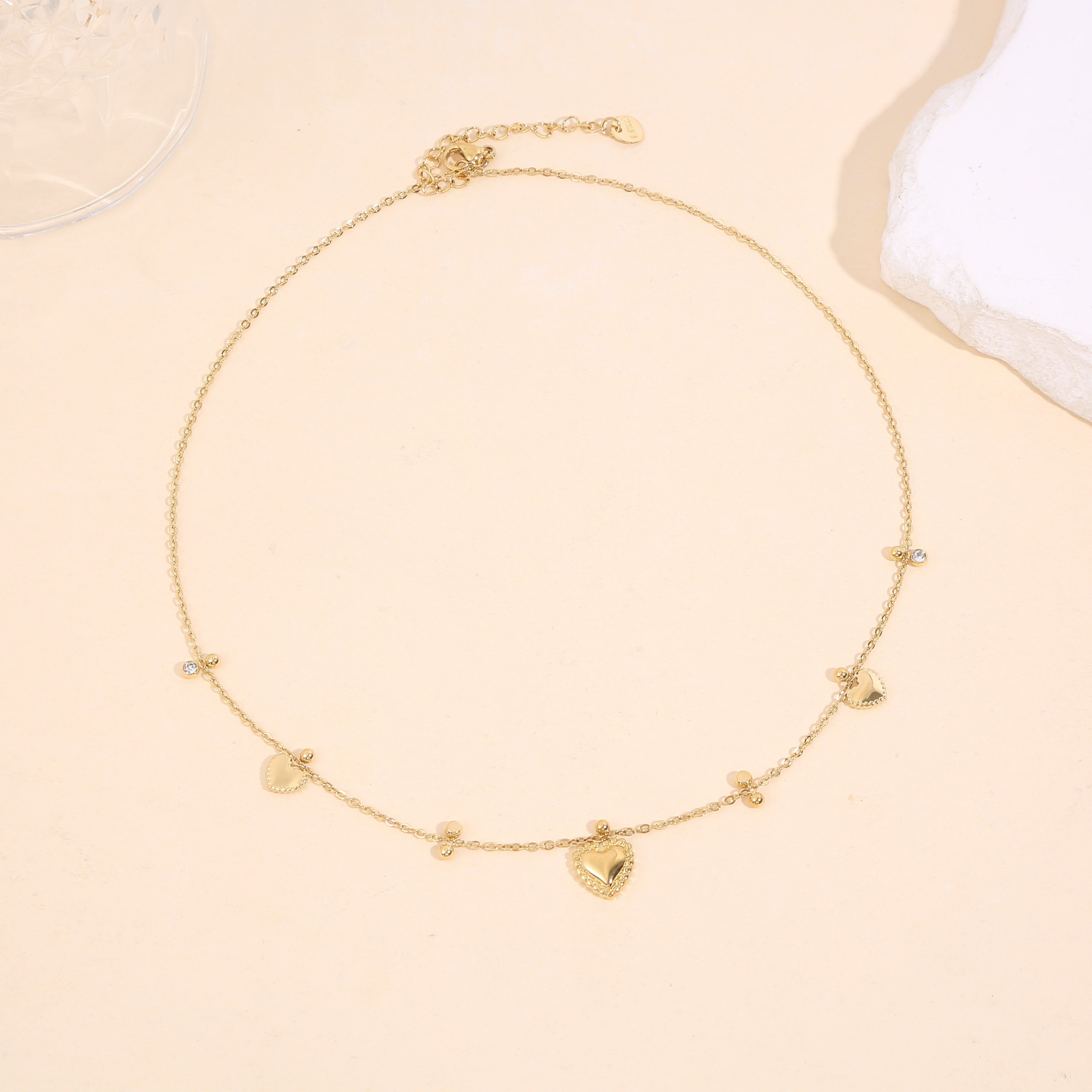 Fine chain necklace adorned with 3 heart pendants of different sizes