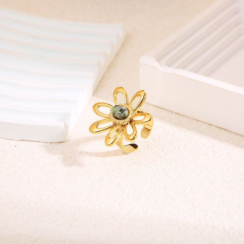 Gold ring with large flower and center stone
