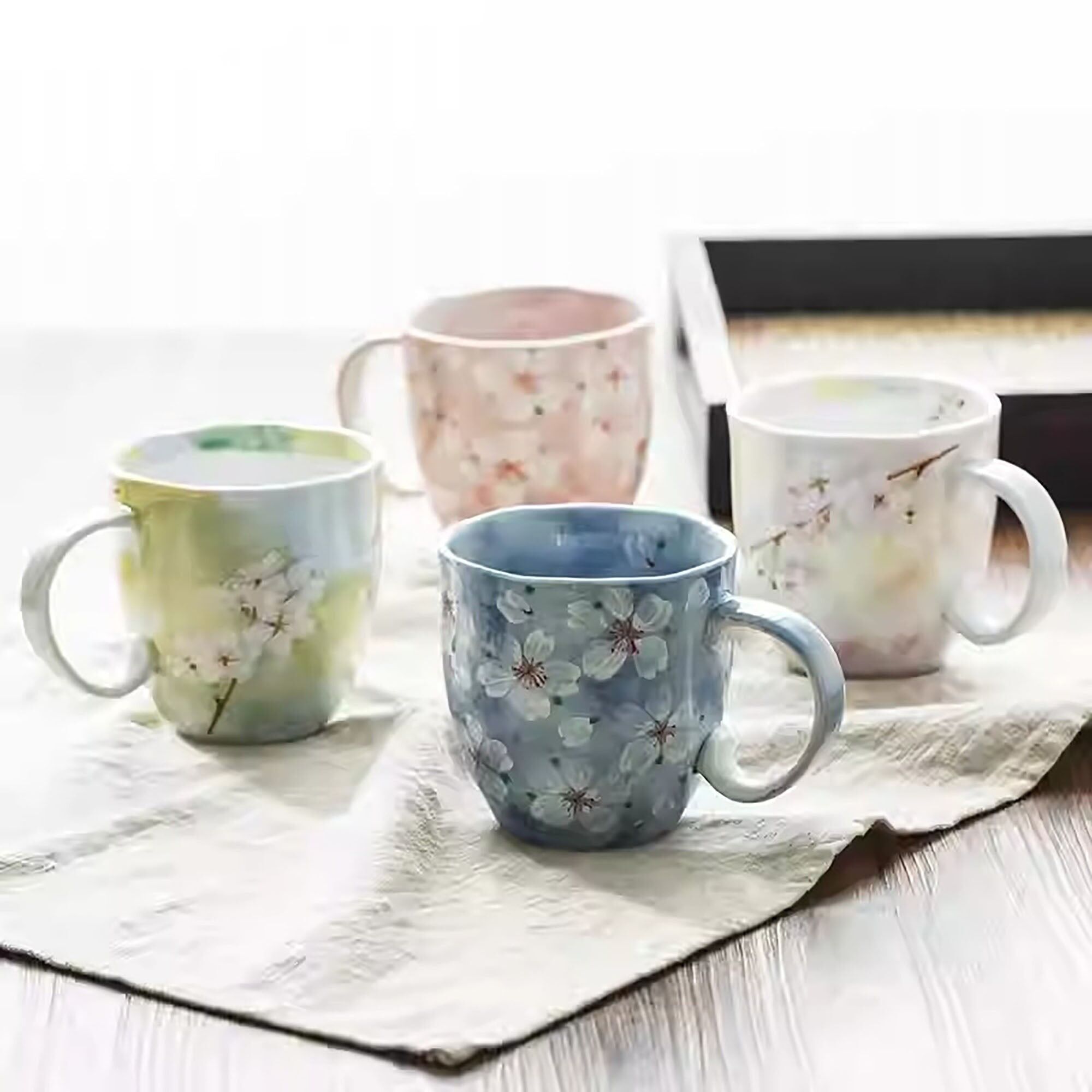 Handmade ceramic mug with cherry blossom pattern