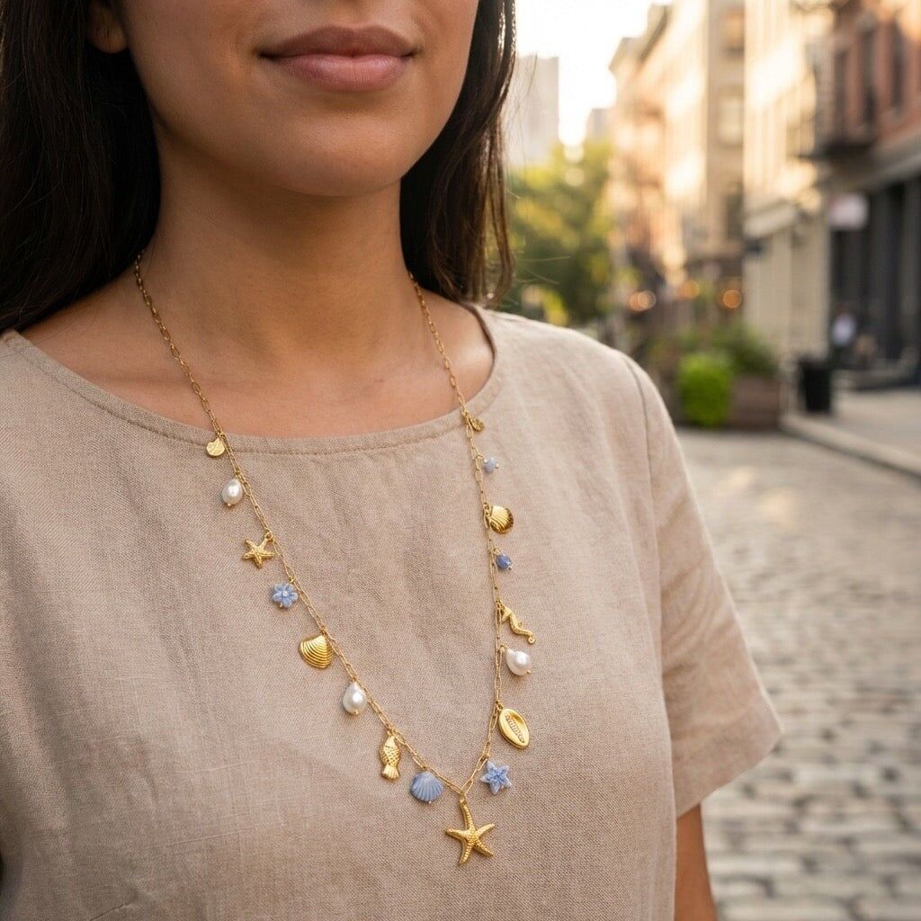 Long necklace with a thin gold chain and pastel blue charms