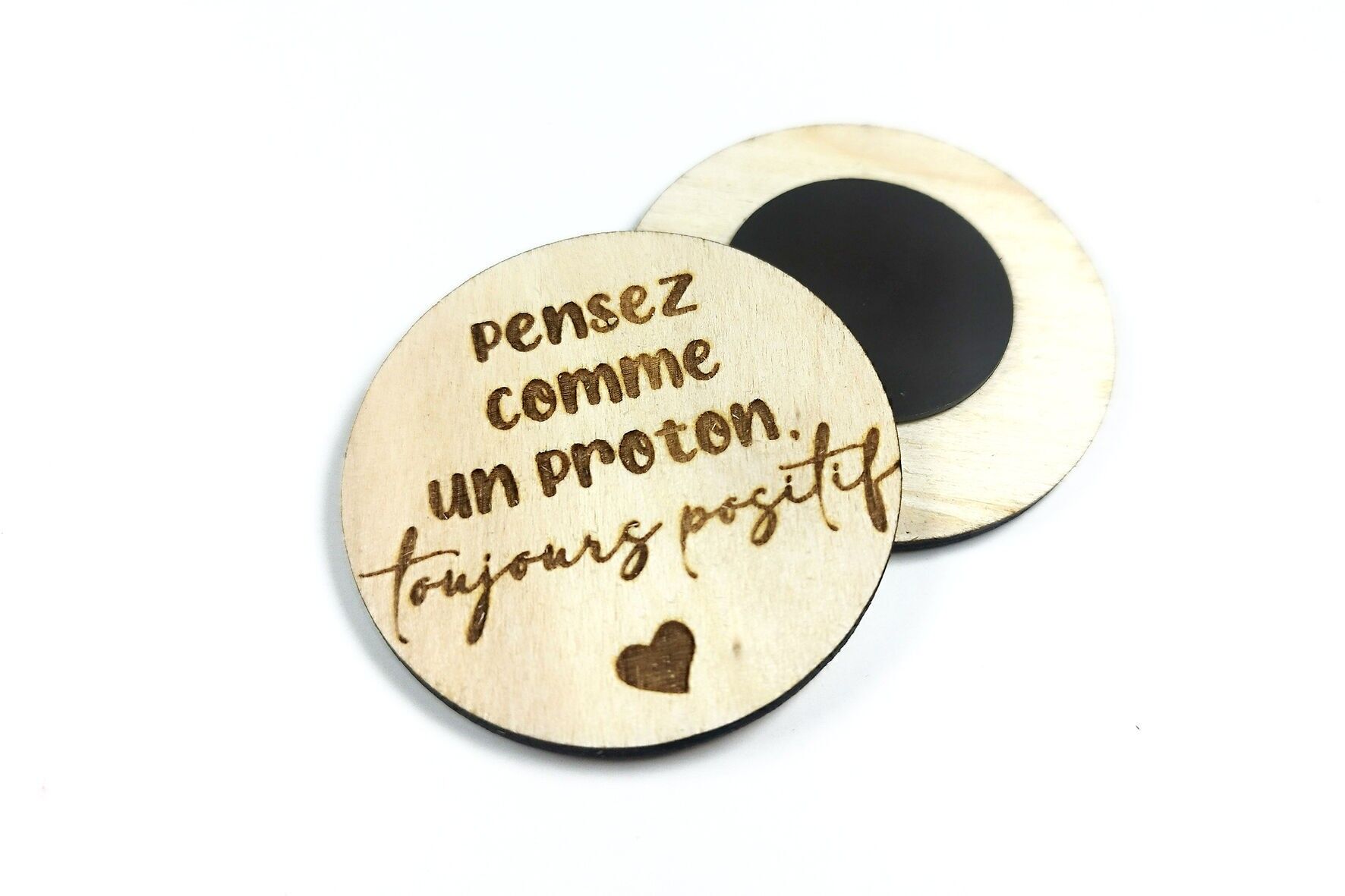Engraved wooden magnets — think like a proton, always positive