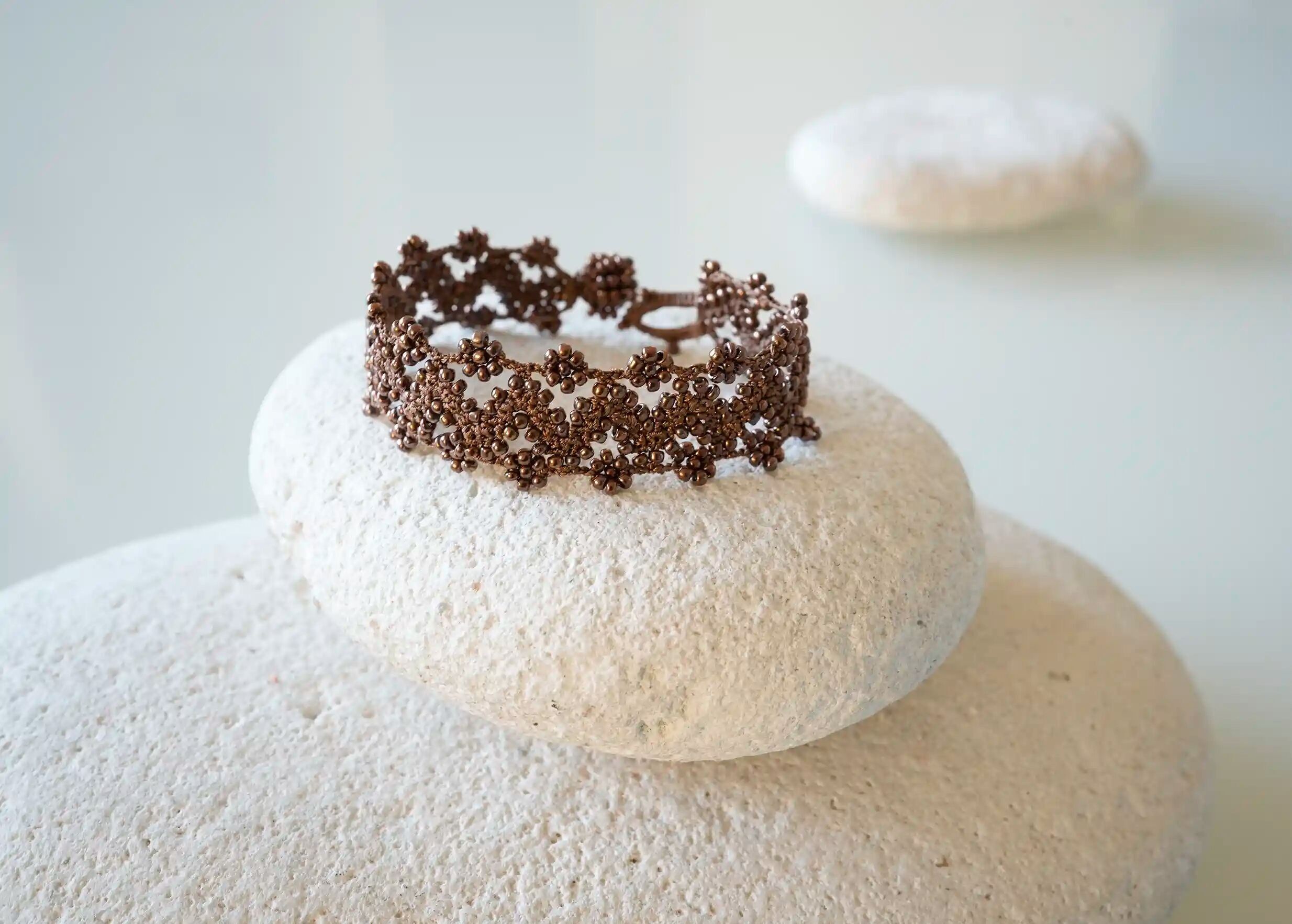 Textile bracelet in thread and beads, with graphic patterns, Ribbon style