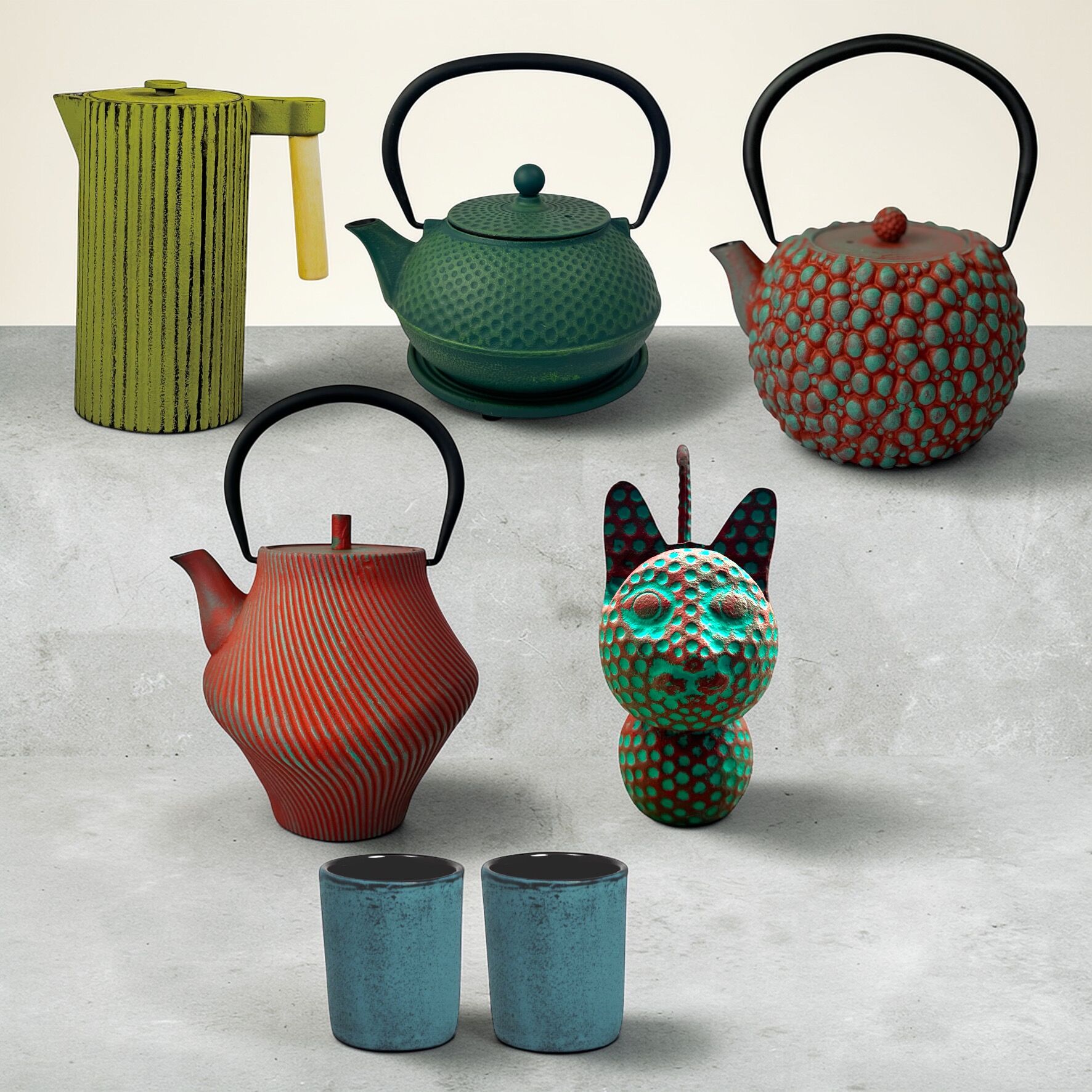 Set regalo in ghisa rosso petrolio-verde: teiere, tazze, brocca e statuetta decorativa.