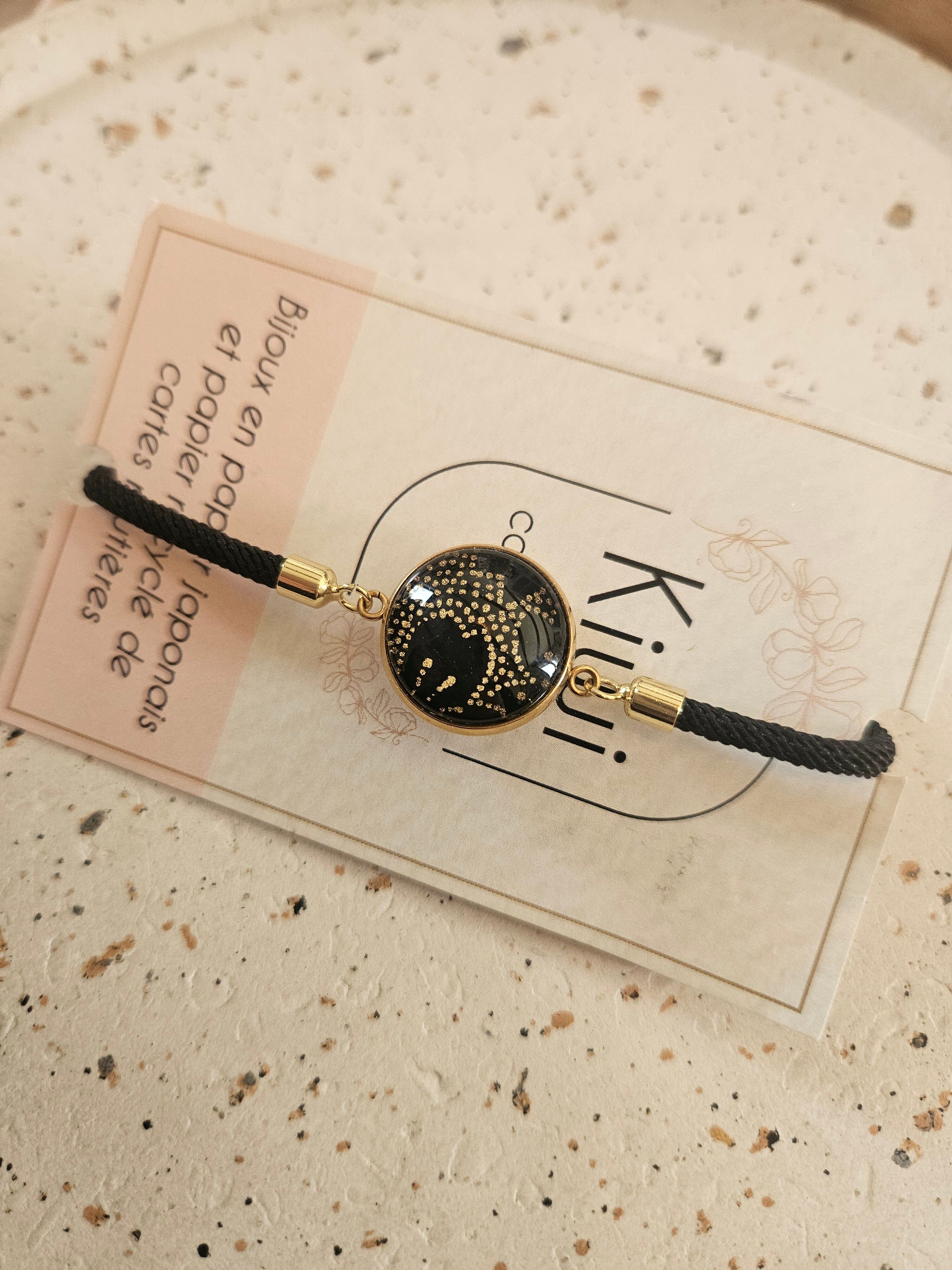 Adjustable black cotton bracelet with black and gold cabochon
