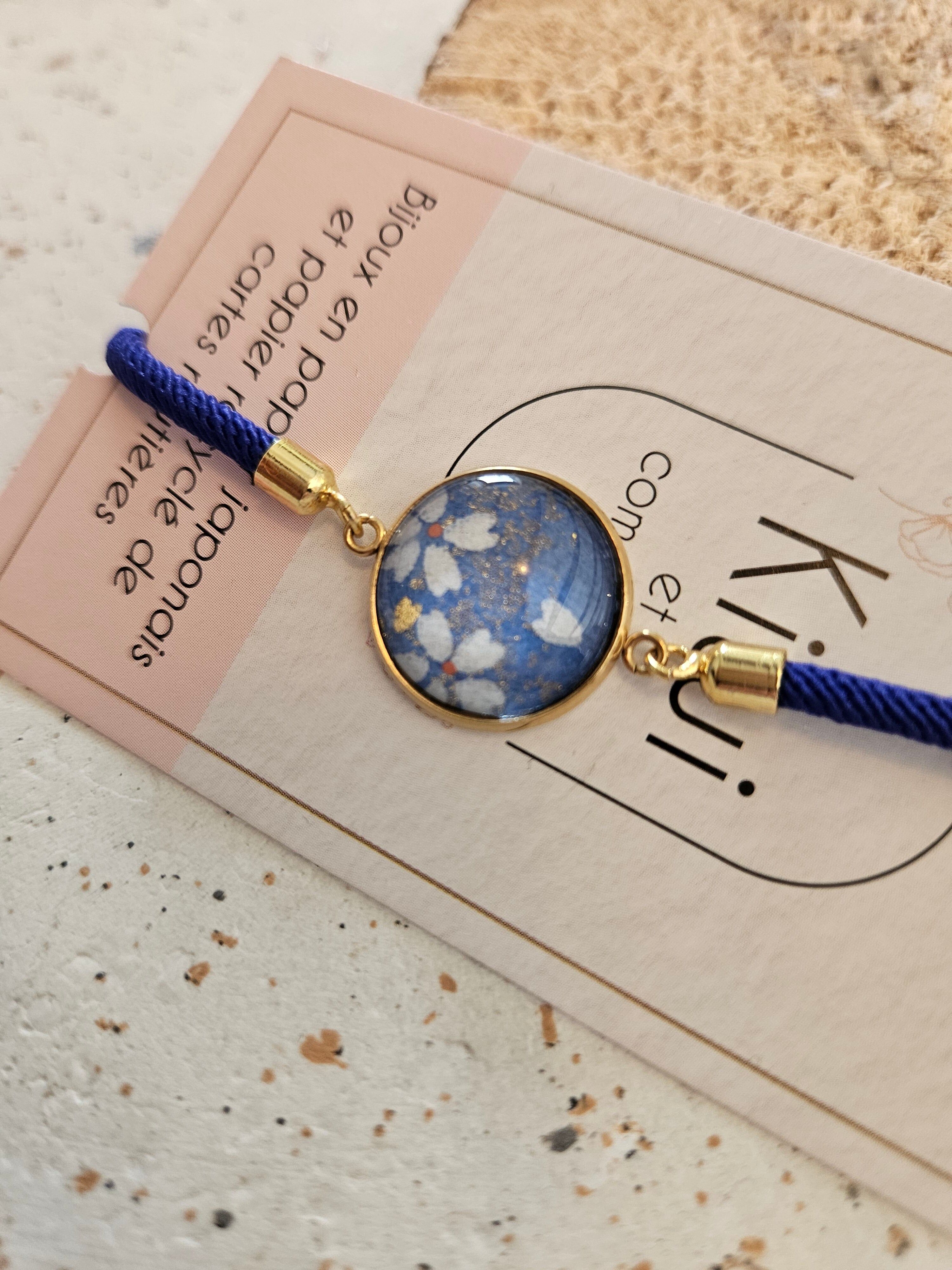 Adjustable navy blue cotton bracelet - light blue cabochon and white flower