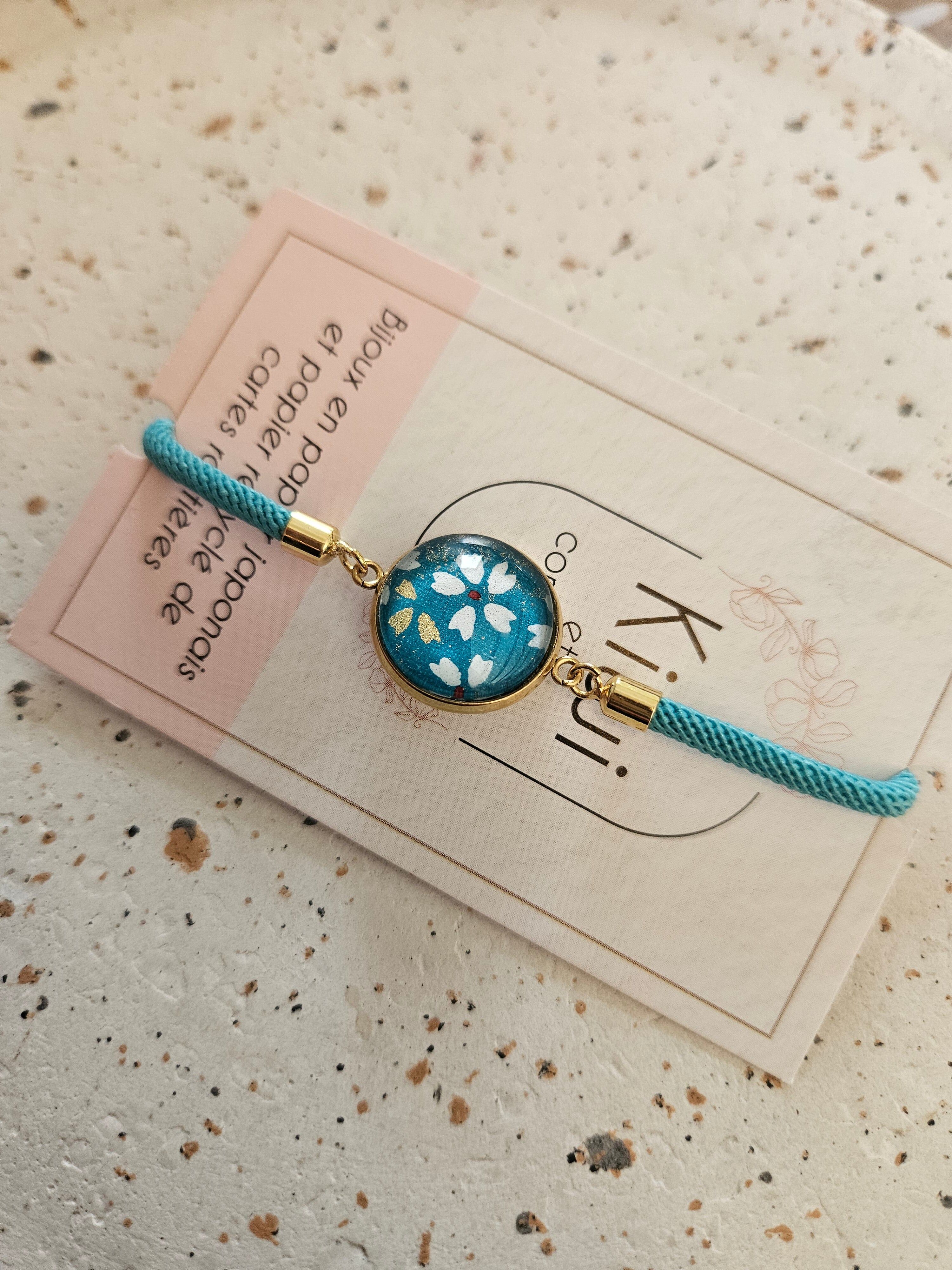 Adjustable blue cotton bracelet - blue cabochon with white flower
