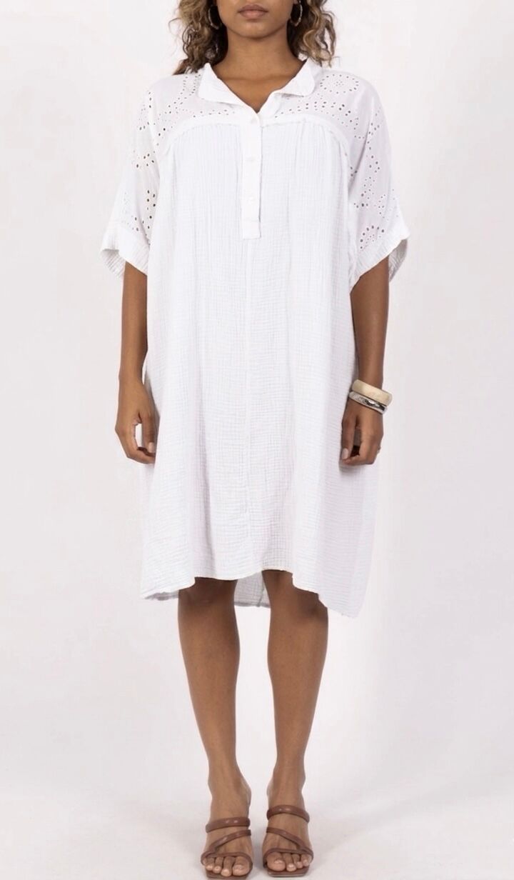 Loose-fitting bohemian tunic dress in cotton gauze with short sleeves, mandarin collar, half-button placket, and openwork eyelet embroidery panels on the bodice
