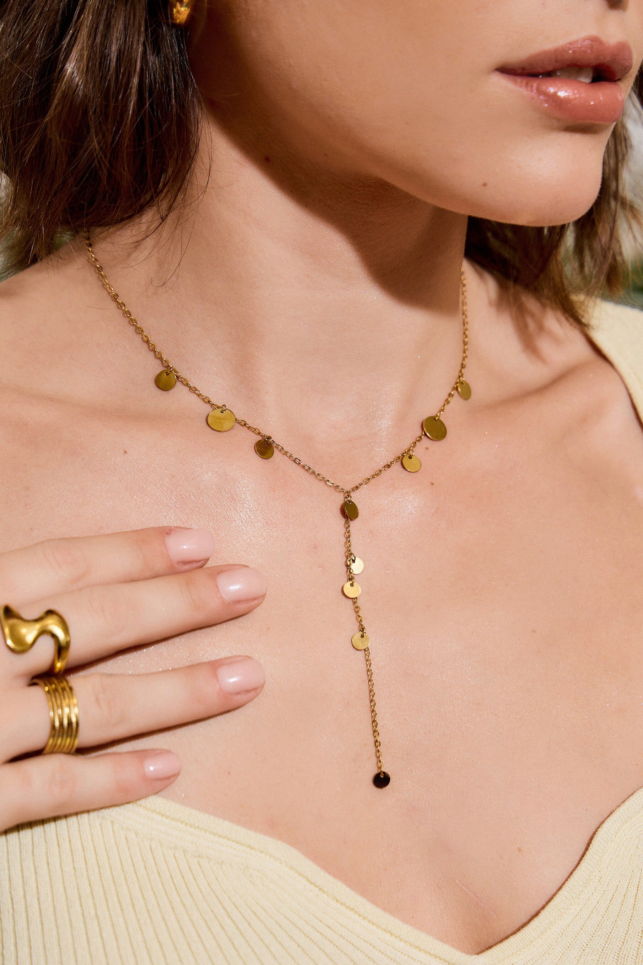 Y-shaped necklace adorned with multiple sparkling discs