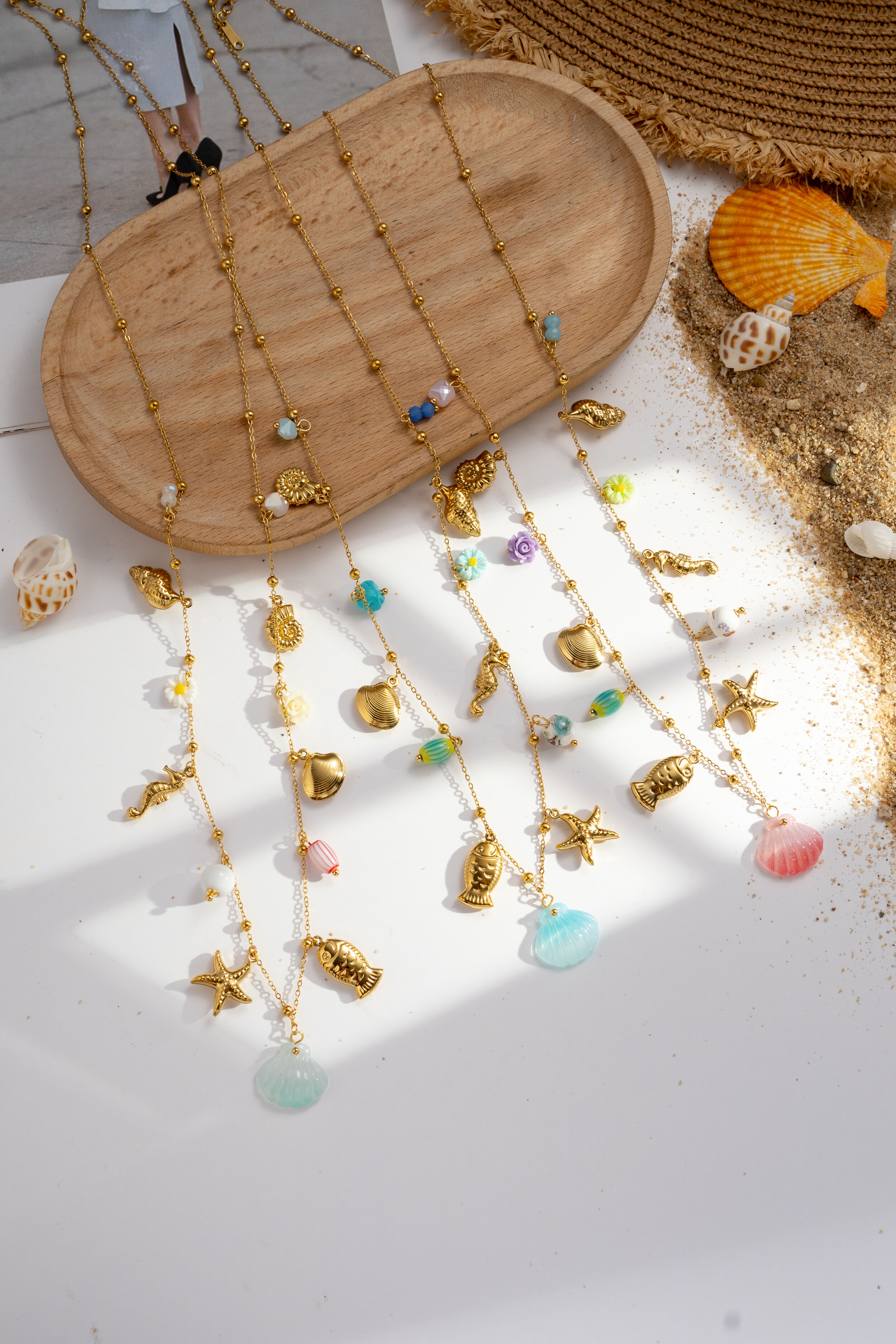 Gold-plated stainless steel necklace with seashell, starfish, and seahorse design, featuring colorful beads for summer.