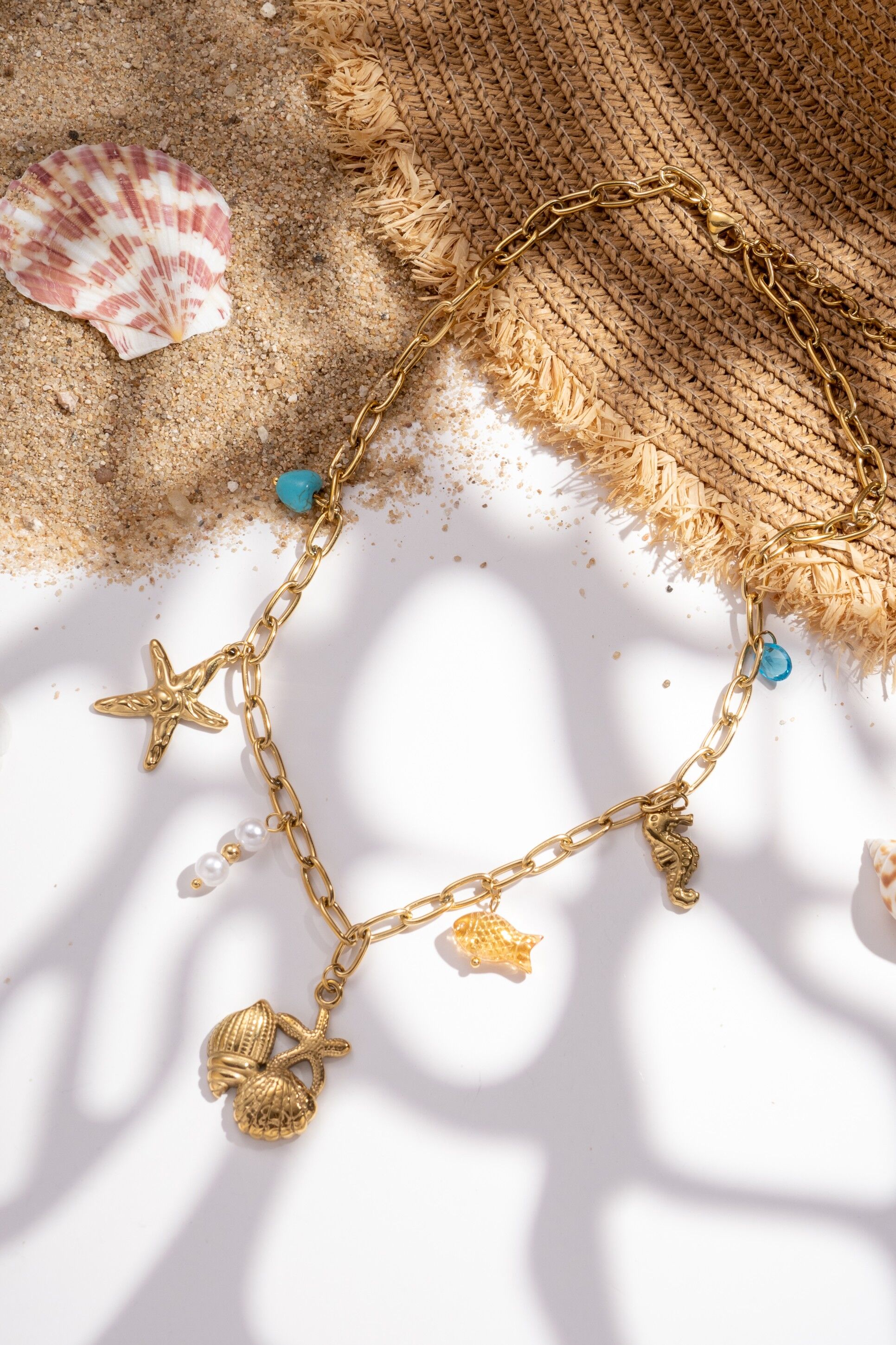 Gold-plated stainless steel necklace with sea star, seahorse, and fish design