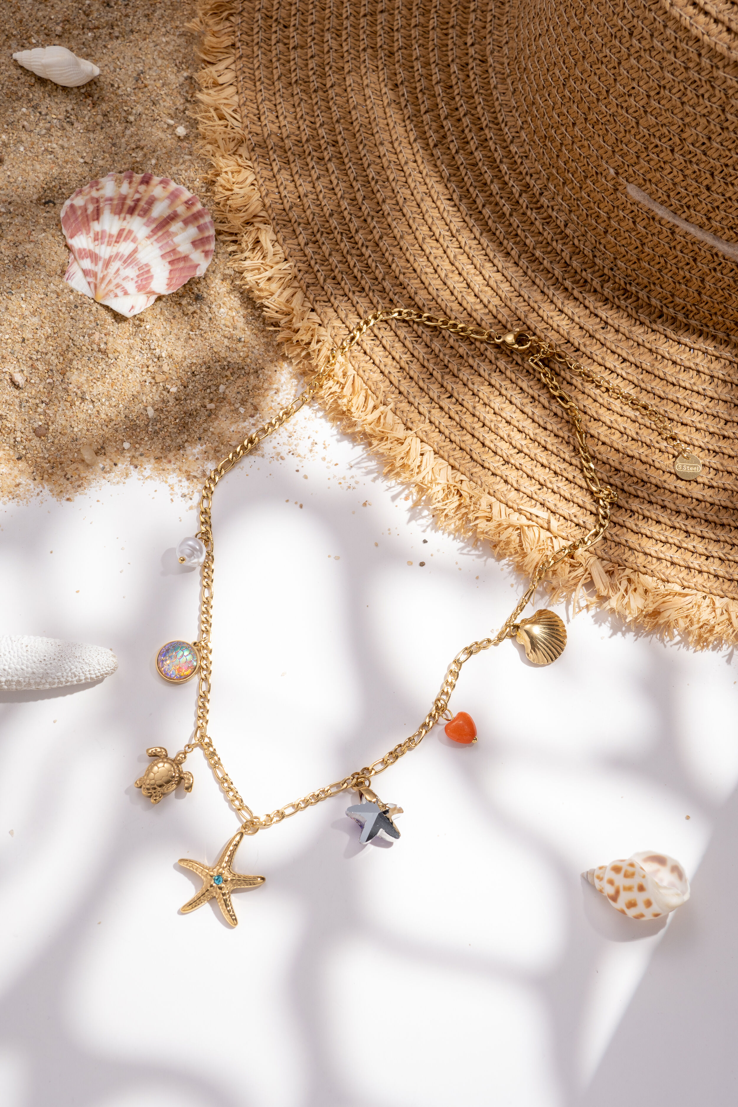 Gold-plated stainless steel necklace with sea, star, turtle, and seashell.