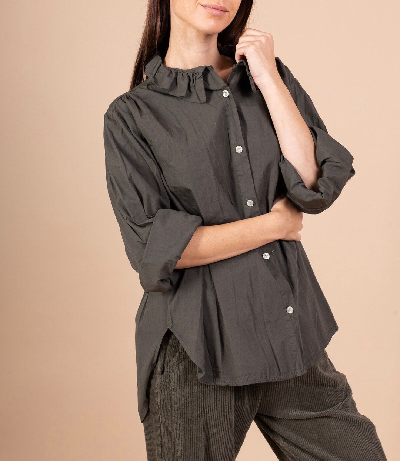 Loose-fitting, long-sleeved shirt with a high, ruffled collar