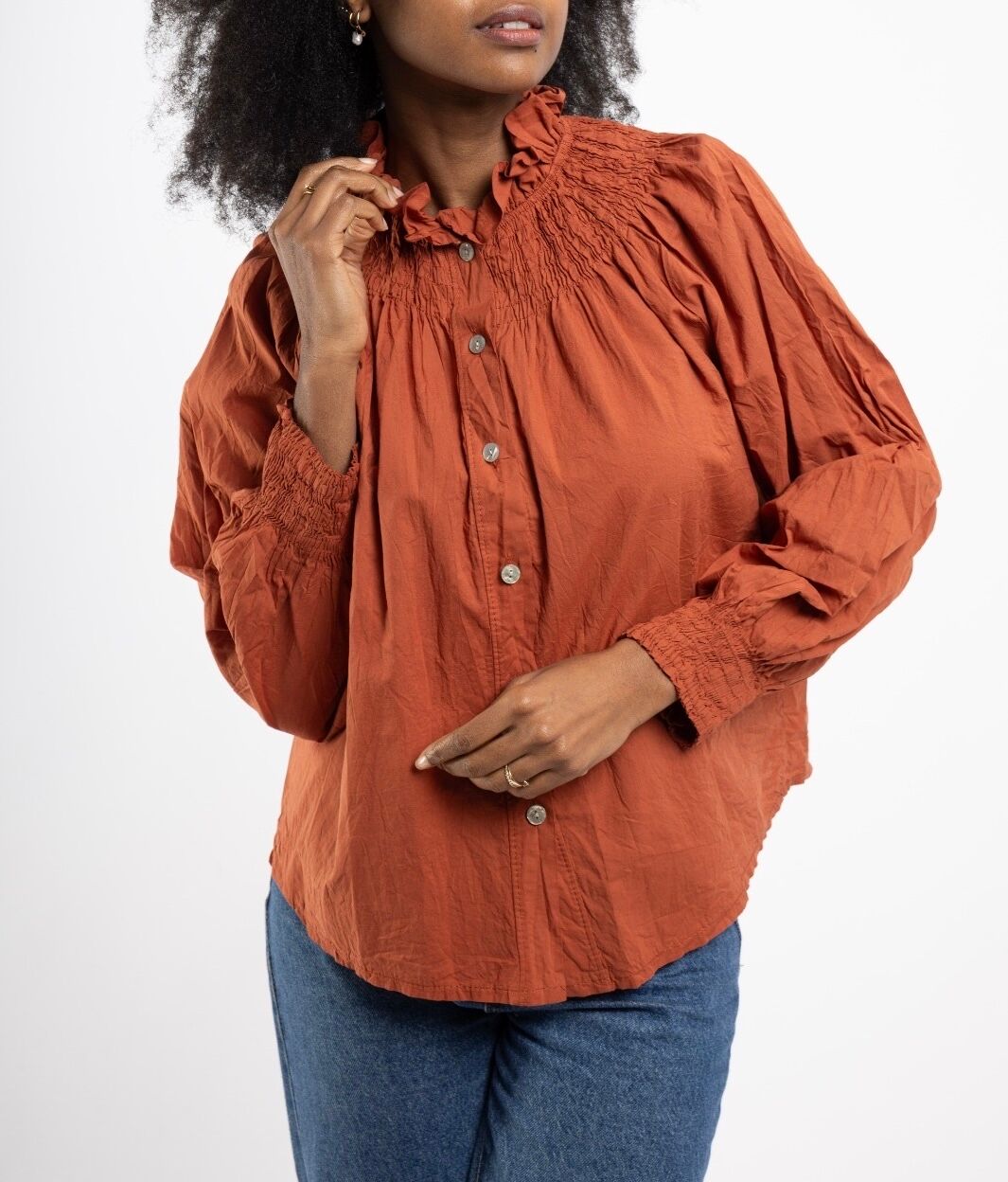 Bohemian shirt with a high, ruffled collar, smocked bib, and gathered elasticated cuffs.