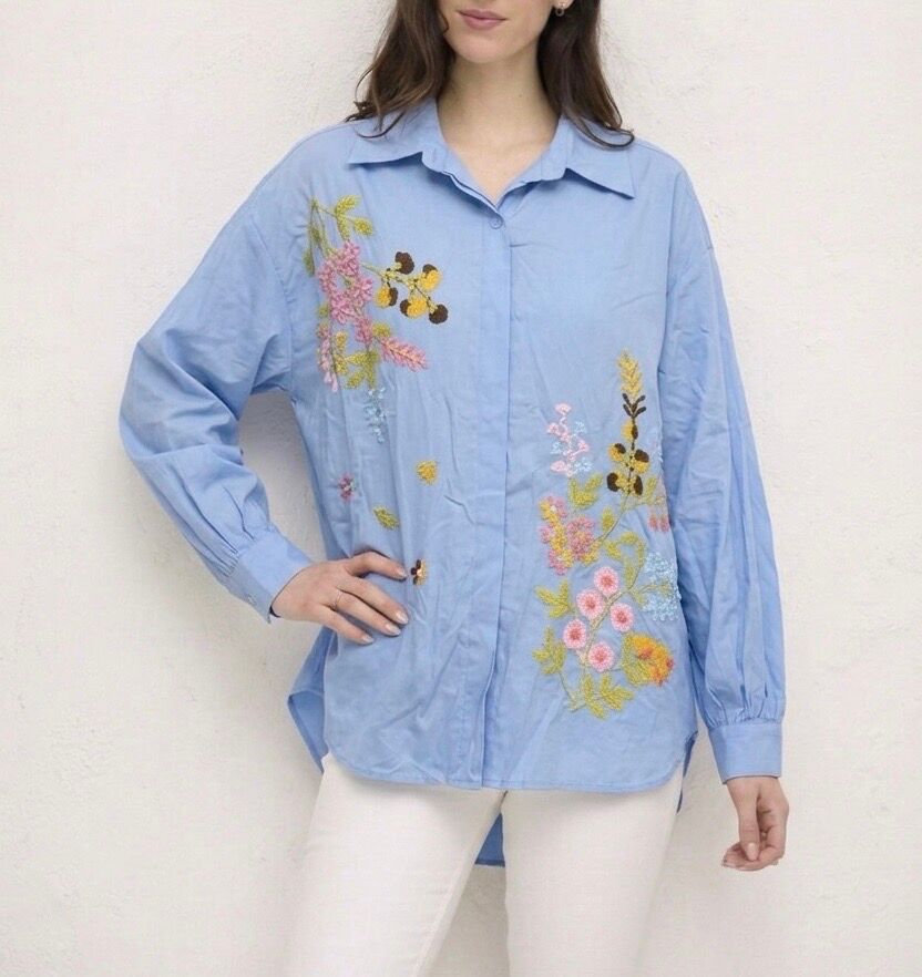 Classic loose-fitting shirt with long sleeves, buttoned cuffs, and floral embroidery.